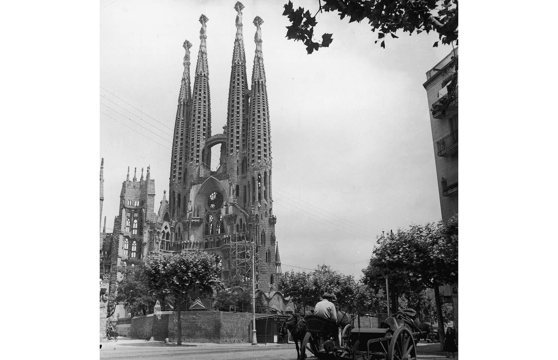 Back on the Spanish mainland, Barcelona became popular as a vacation destination among wealthy Europeans following the World's Fair in 1888. Although the Spanish Civil War and both World Wars halted the growth of tourism, the city came back with a boom in the 1950s. One of the city's most striking landmarks, Sagrada Família, had grown quite considerably by that time as well, attracting many visitors eager to see the impressive and unusual cathedral. Here, it's pictured in 1954.