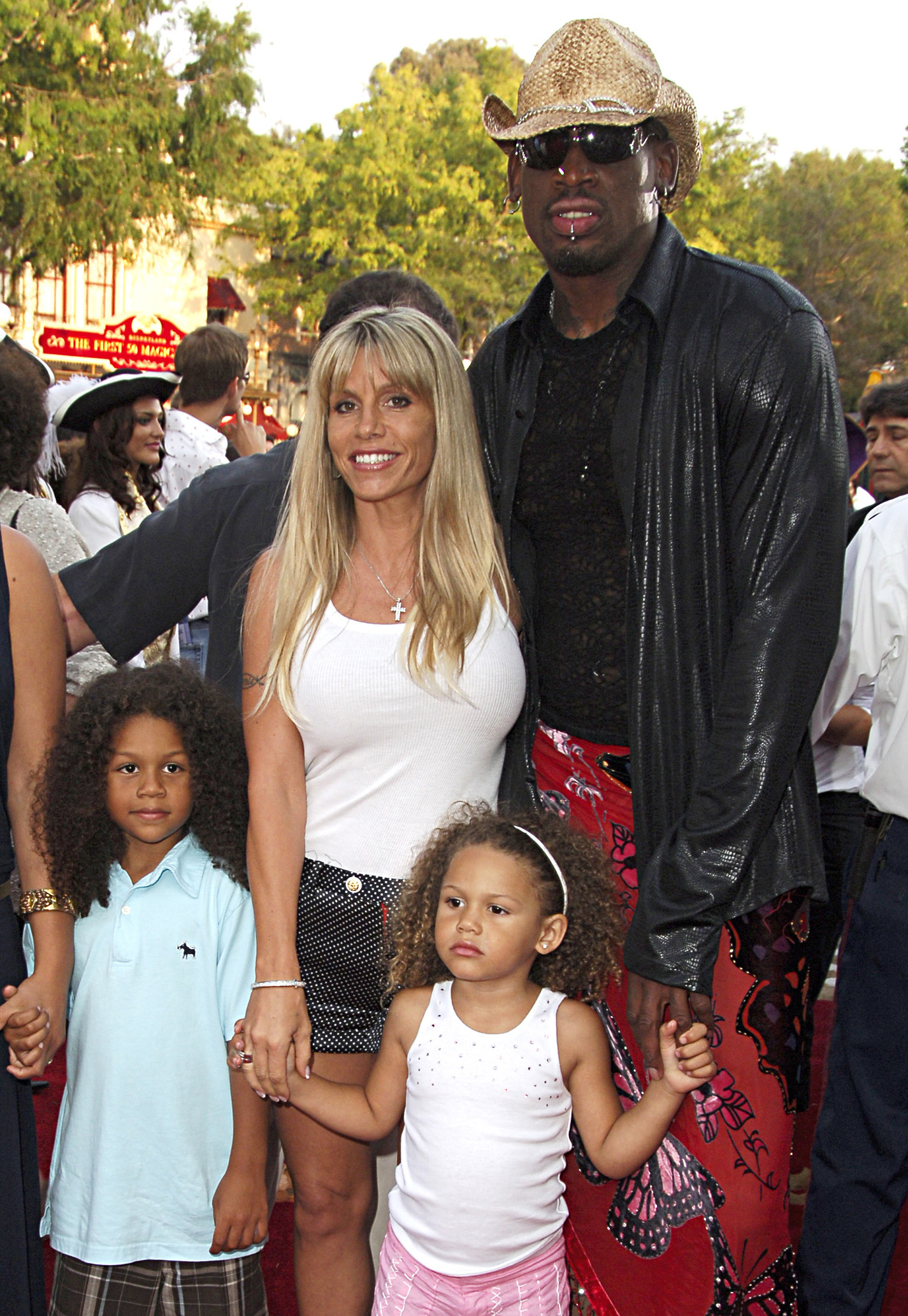 <p>Former professional basketball star and pop culture personality Dennis Rodman, third wife Michelle Moyer and their kids -- then-5-year-old Dennis Rodman Jr., who goes by DJ, and then-3-year-old Trinity Rodman -- attended the world premiere of "Pirates of the Caribbean: Dead Man's Chest" at Disneyland in Anaheim, California, in June 2006. (Dennis is also a dad to daughter Alexis, not pictured, from his first marriage to model Annie Bakes.) </p>