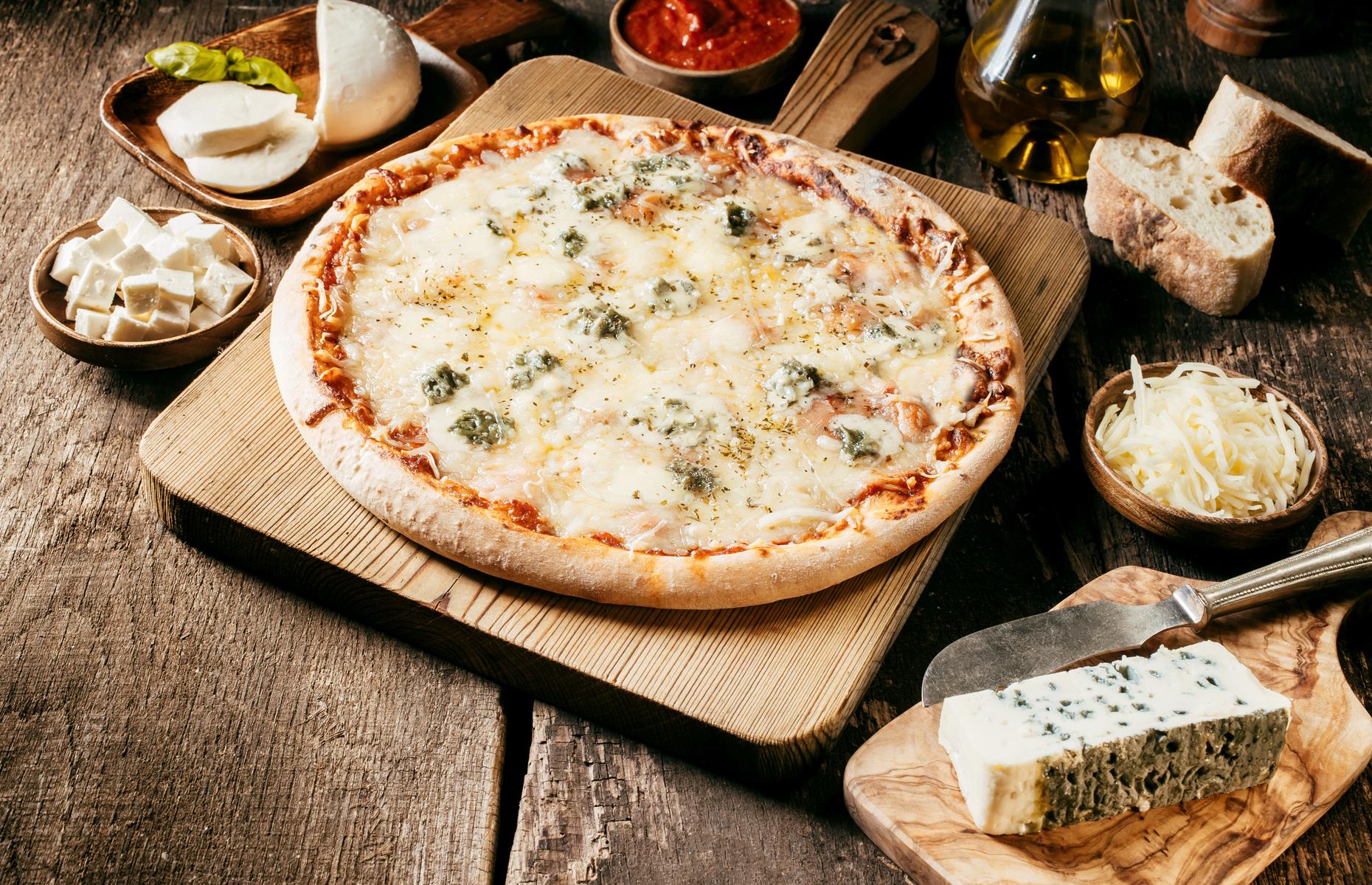 Quattro formaggi, four cheese pizza, is always a big hit. But which cheeses should you use? The Italians often combine mozzarella, Gorgonzola, Parmesan and fontina, which is a very good melting cheese. You could substitute it with Emmental. The blue cheese must be soft and creamy, with a good strong flavor.