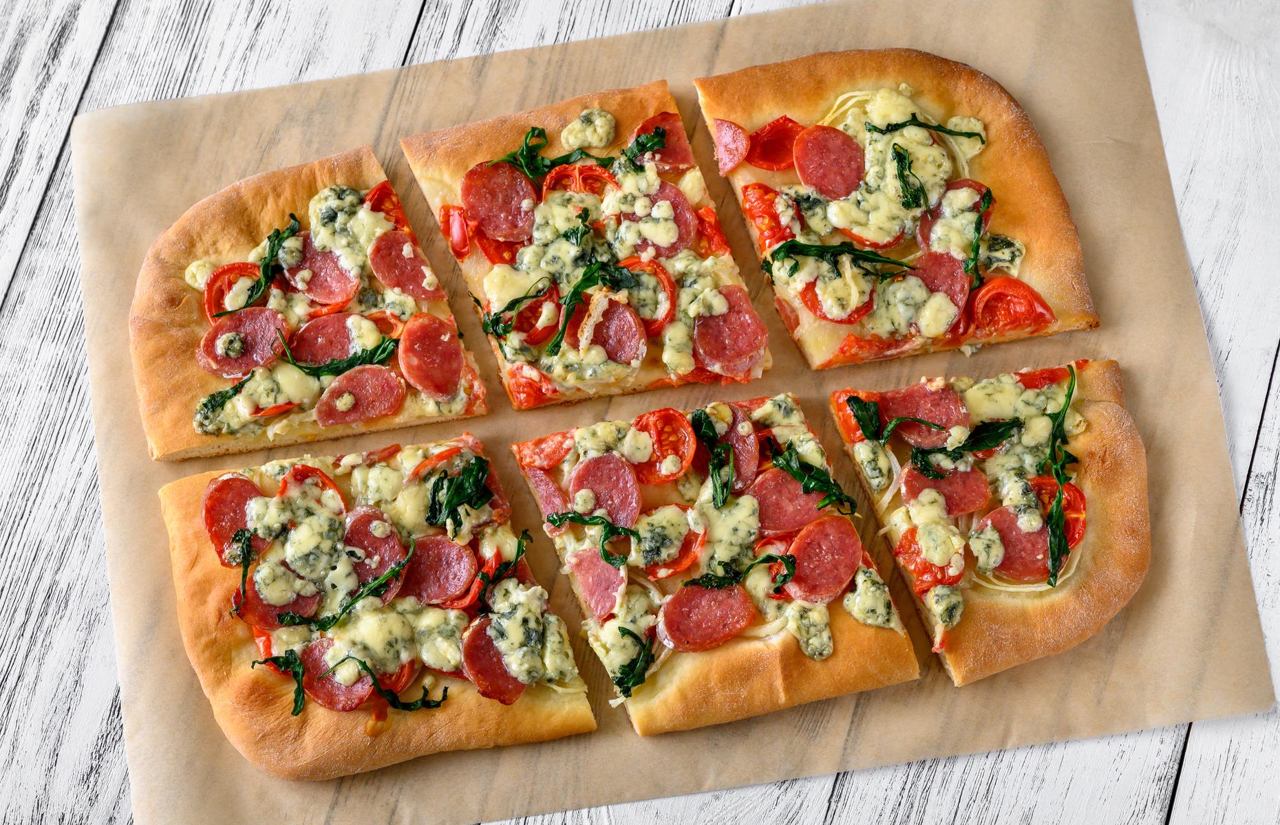 <p>In northern Spain, these pizzas are known as coca. Rectangular in shape, they are topped with tomato, a local creamy blue cheese, garlic, smoked paprika and a local sausage similar to salami or chorizo. It's a very good combination for any pizza.</p>  <p><a href="https://www.lovefood.com/recipes/58369/spanish-pizza-coca-with-soft-blue-cheese-and-cured-sausage"><strong>Get the recipe for coca here</strong></a></p>