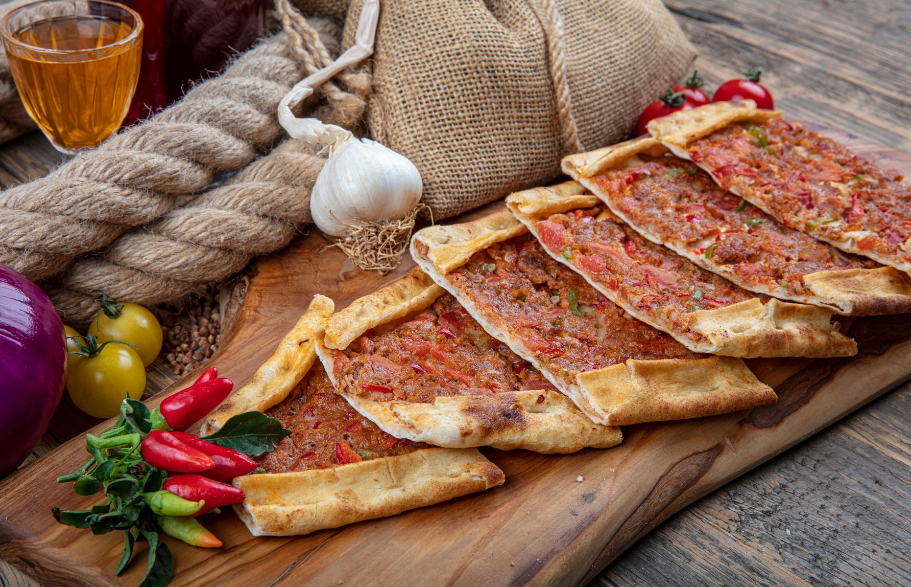 <p>Popular in North Africa and Turkey, these spicy lamb pizzas called pide are often sold as street food. The dough is similar to pizza dough, although it contains oil so the base can be rolled very thinly. The ground lamb is flavored with chili, tomato, garlic and dried mint, which is much more intense than fresh. Traditionally, there's no cheese but it's tasty with some feta crumbled over.</p>  <p><a href="https://www.lovefood.com/recipes/58361/lamb-pizza-lahma-bi-ajeen"><strong>Get the recipe for pide here</strong></a></p>
