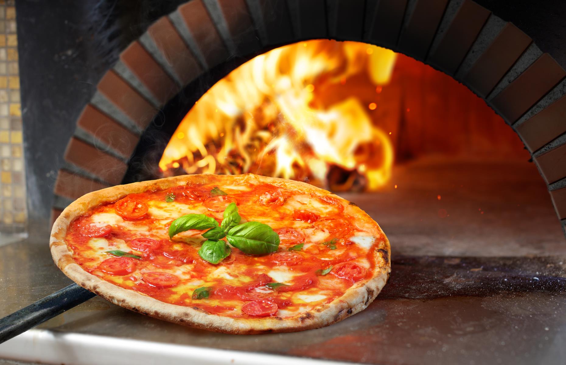 Most of us don't have the luxury of a pizza oven at home, so what's the best way to get that crisp base? The oven needs to be at its hottest and use a pre-heated baking stone, metal pizza dish, baking tray or cast iron pan. This almost replicates a pizza oven, ensuring the base sears quickly and is evenly crisp. Alternatively, start the pizza in a very hot cast iron pan on the hob, then pop it under the grill to brown the top.