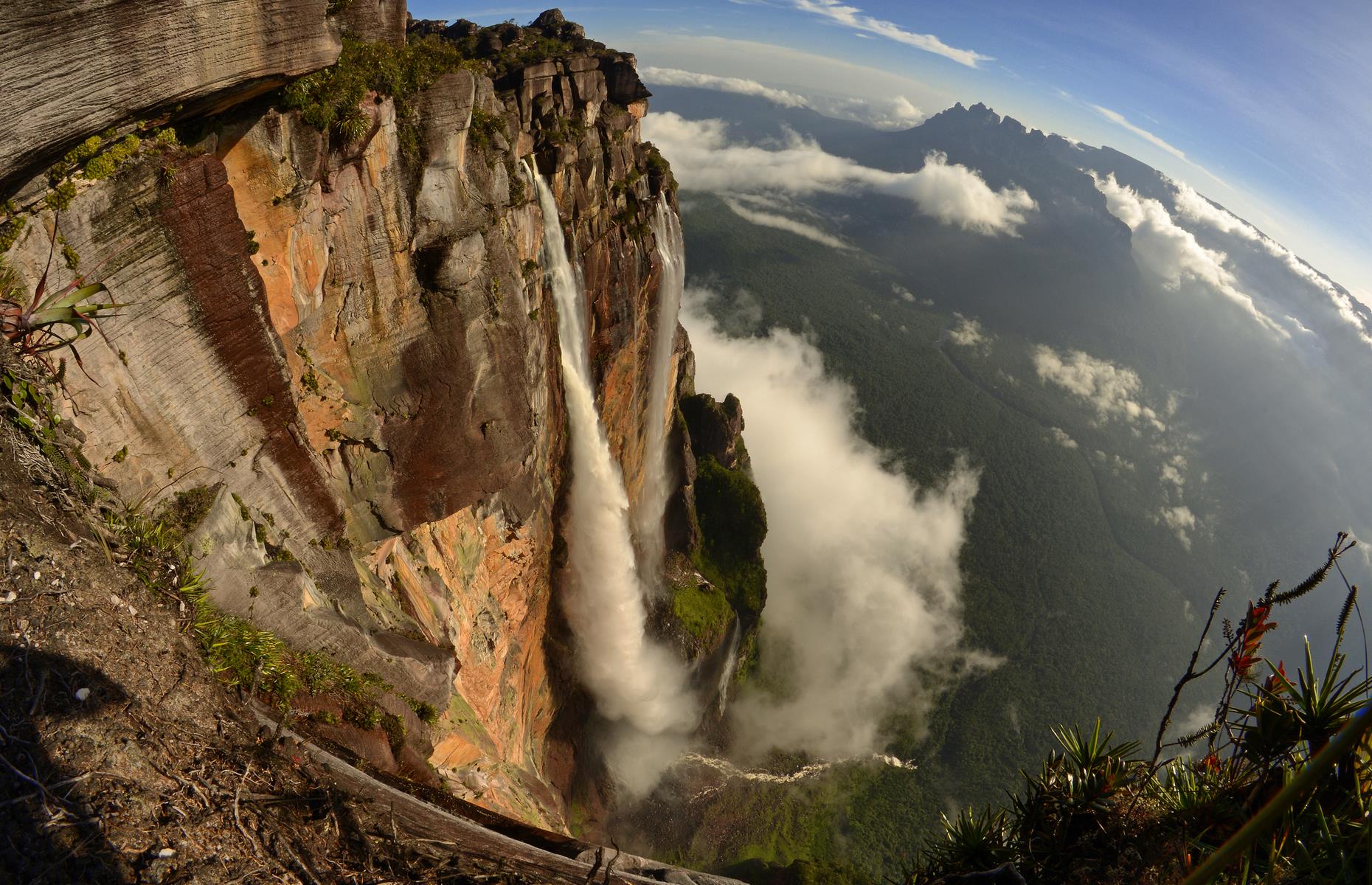 <p>Plummeting 3,212 feet (979m) over the edge of the Auyán-tepui mountain and into the Churún River, the awe-inspiring Angel Falls is the world’s tallest waterfall. Equally dramatic is its remote location in southeastern Venezuela's Canaima National Park, with its striking flat-topped mountains and mist-shrouded forests. There are only two ways to see the falls – from above on a scenic flight in a light aircraft or on an arduous journey by boat and on foot through the dense jungle.</p>