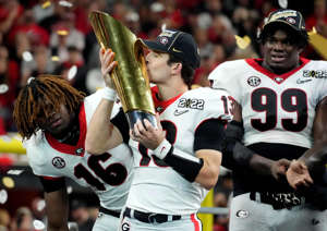 Georgia quarterback Stetson Bennett kisses the national championship trophy after the Bulldogs defeated the Crimson Tide.