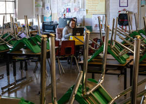 A teacher interacts with students virtually while sitting in an empty classroom during a period of Non-Traditional Instruction (NTI) at Hazelwood Elementary School on Jan. 11, 2022 in Louisville, Ky. Jefferson County Public Schools, along with many other school districts in the US, have switched to NTI in response to severe staffing shortages caused by the prevalence of the omicron variant of COVID-19.