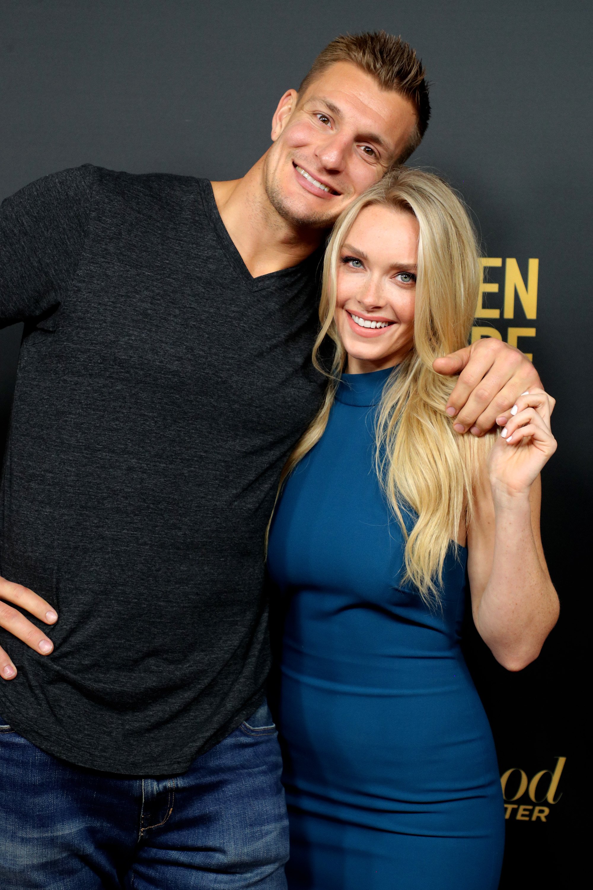 <p>Tampa Bay Buccaneers tight end Rob Gronkowski's long romance with Sports Illustrated Swimsuit Issue model Camille Kostek was sparked at a charity event. "It was November 2013 and we were at a Goodwill event. It was right before Thanksgiving. So we were filling turkey baskets for families who are less fortunate," Camille recalled in an interview on SiriusXM's "This is Happening with Mark Zito and Ryan Sampson" that aired in February 2021, as reported by Fox News. He played for the New England Patriots then, and she was a new cheerleader for the team. "He ripped off his 'Hi, my name is Rob Gronkowski' sticker on his shirt ... he had written on the back of it his phone number and then he wrote 'Shhh,' because he knew it was ... a secret." Retired tight end Jermaine Wiggins passed her the name tag. "I was a rookie [cheerleader] and I was so scared. I was like, 'Oh no, no, no, I can't take this. I can't take his number.' And then [Jermaine] was like, 'Just take it,' and I was like, 'OK,' and I put it in my pocket," she recalled. "I didn't make it locker room talk. I never spoke about it." Several days later, she FaceTimed Gronk "and I put my phone down and I like, looked away from it. And then he answered it and he didn't look either. I was like, 'Hello.' He was like, 'Who is this? You called me.' And I was like, 'Um, who's this?' I could tell it was his voice and he like, peeked his head over." Camille added, "He had just gotten back from a Texans game so he had like, a suit on and everything. And he was like, 'Hello?' And I was like, 'It's Camille.' And he was beaming. 'He was like, Oh my God, I never thought you'd call me.'" The rest is history!</p>