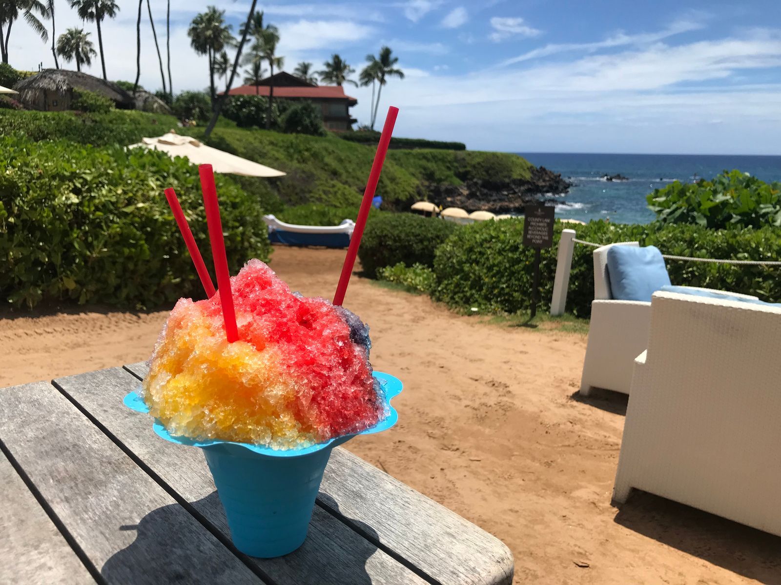 <p>A Hawaiian snow cone (called “shave ice” by locals) is a small mountain of <a href="https://www.hawaiianairlines.com/hawaii-stories/food-and-entertainment/shave-ice-history" rel="noreferrer noopener">shaved ice (not crushed, giving it an almost powdery consistency</a>) topped with colourful flavoured syrups. Absolutely refreshing!</p>