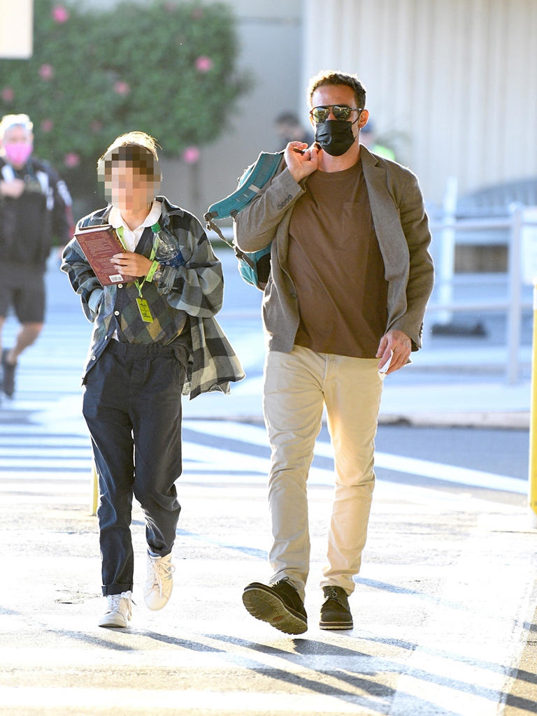 Ben Affleck walks out of Hollywood Burbank Airport with his daughter Seraphina Affleck on Oct. 17, 2021. The doting dad wore a sharp jacket while his daughter was in a school uniform.