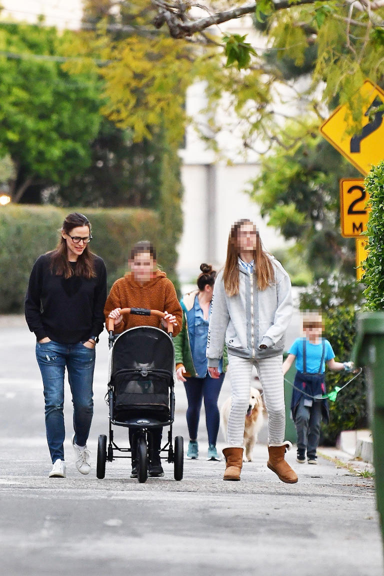 Jennifer Garner breaks from isolation with her three kids Violet, Seraphina and Samuel for a casual walk outside of their Brentwood home. Seraphina appeared to be pushing along a small animal in a stroller while Violet towered over her mom.