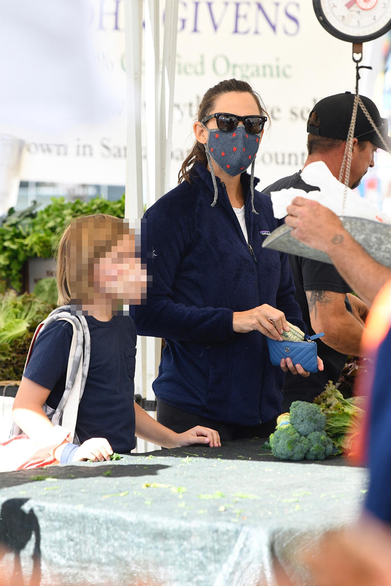 Jennifer Garner takes son Samuel Affleck for a trip out to the Brentwood Farmer’s Market on Oct. 10, 2021. Jen had a face mask on and wore a casual blue zip-up jacket while looking at the produce with her youngest at her side.