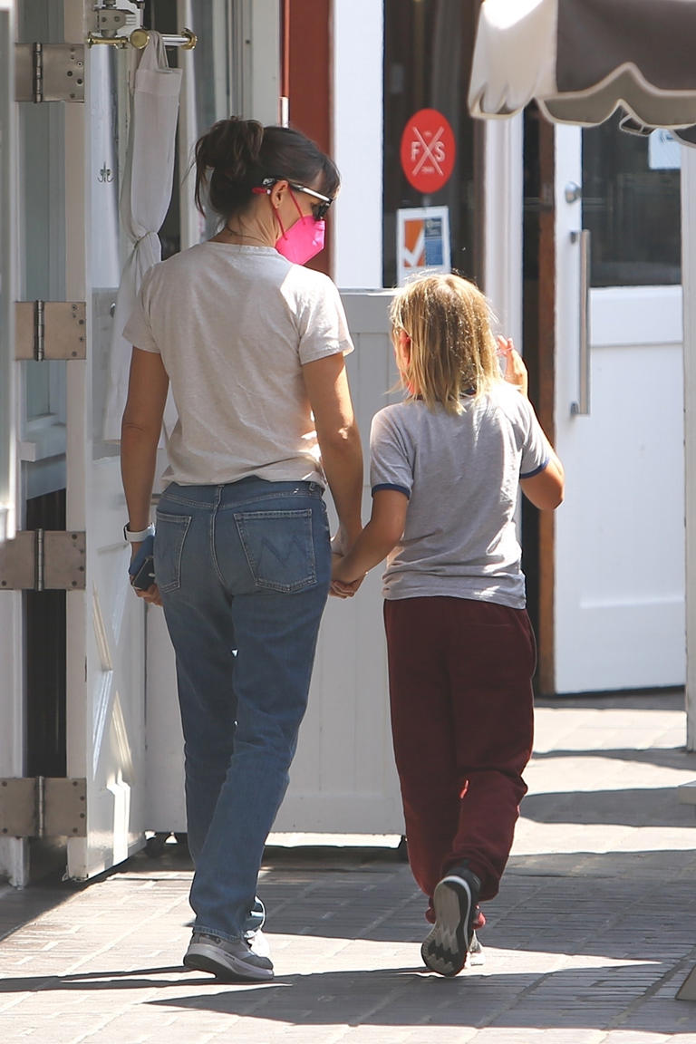 Jennifer Garner and her son Samuel hold hands during a lunch date at the Brentwood Country Mart in Los Angeles on Sept. 3, 2021. They looked deep in conversation as they strolled to the restaurant.