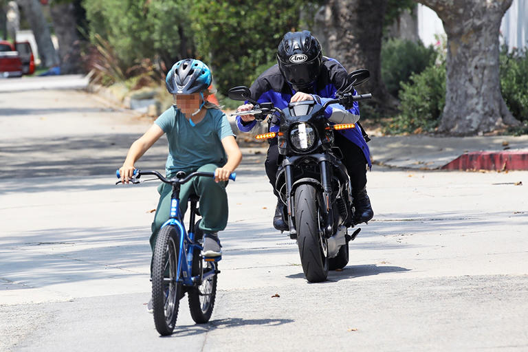 Ben Affleck follows his son Sam during a ride together. Ben cruised behind his son on his motorcycle while Sam went with a classic bike.