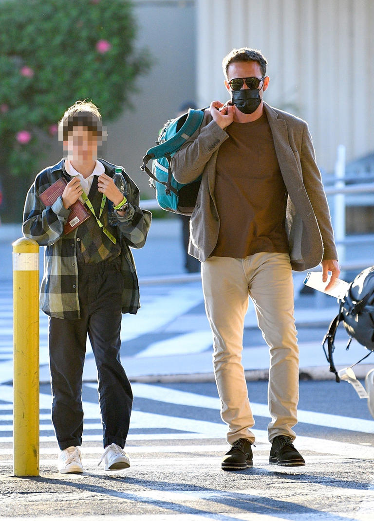 Ben Affleck carries daughter Seraphina’s bag as he picks her up from the Burbank airport in Los Angeles, Calif. on October 17, 2021. Ben was masked up for the stop.