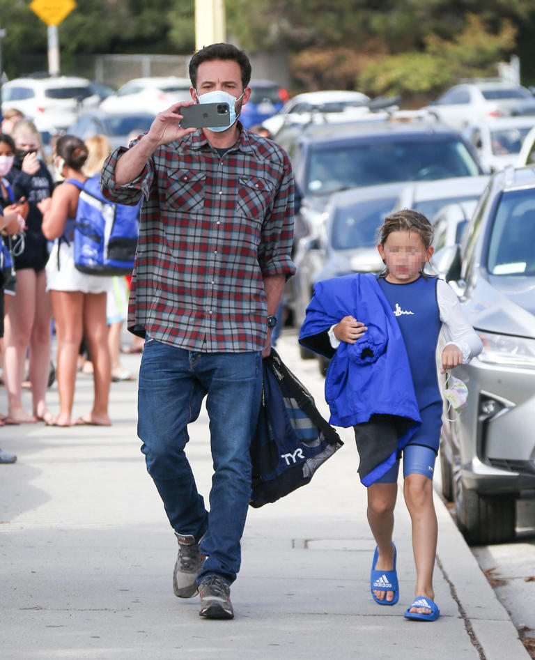 Ben Affleck picks son Samuel Affleck to a swim lesson in Los Angeles on May 14, 2021, a week after his getaway to Montana with J.Lo. He wore a plaid shirt and jeans while FaceTiming with someone.