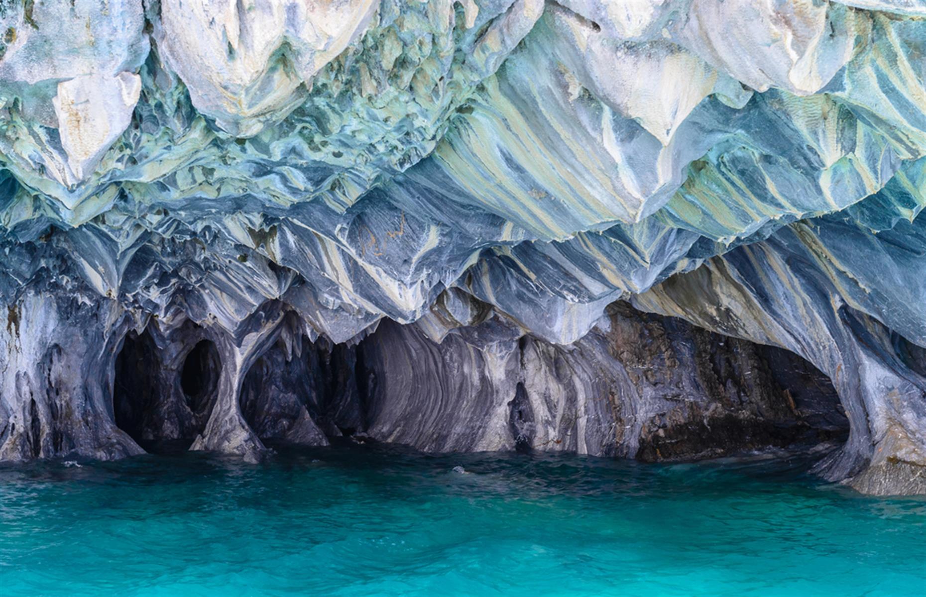 Waves crashing into solid calcium carbonate for 6,000 years is what created Chile’s incredible marble caves. Their swirling blue pattern changes color and intensity throughout the year. You’ll need to join a boat tour to visit these caves as they’re in the middle of Lake General Carrera.