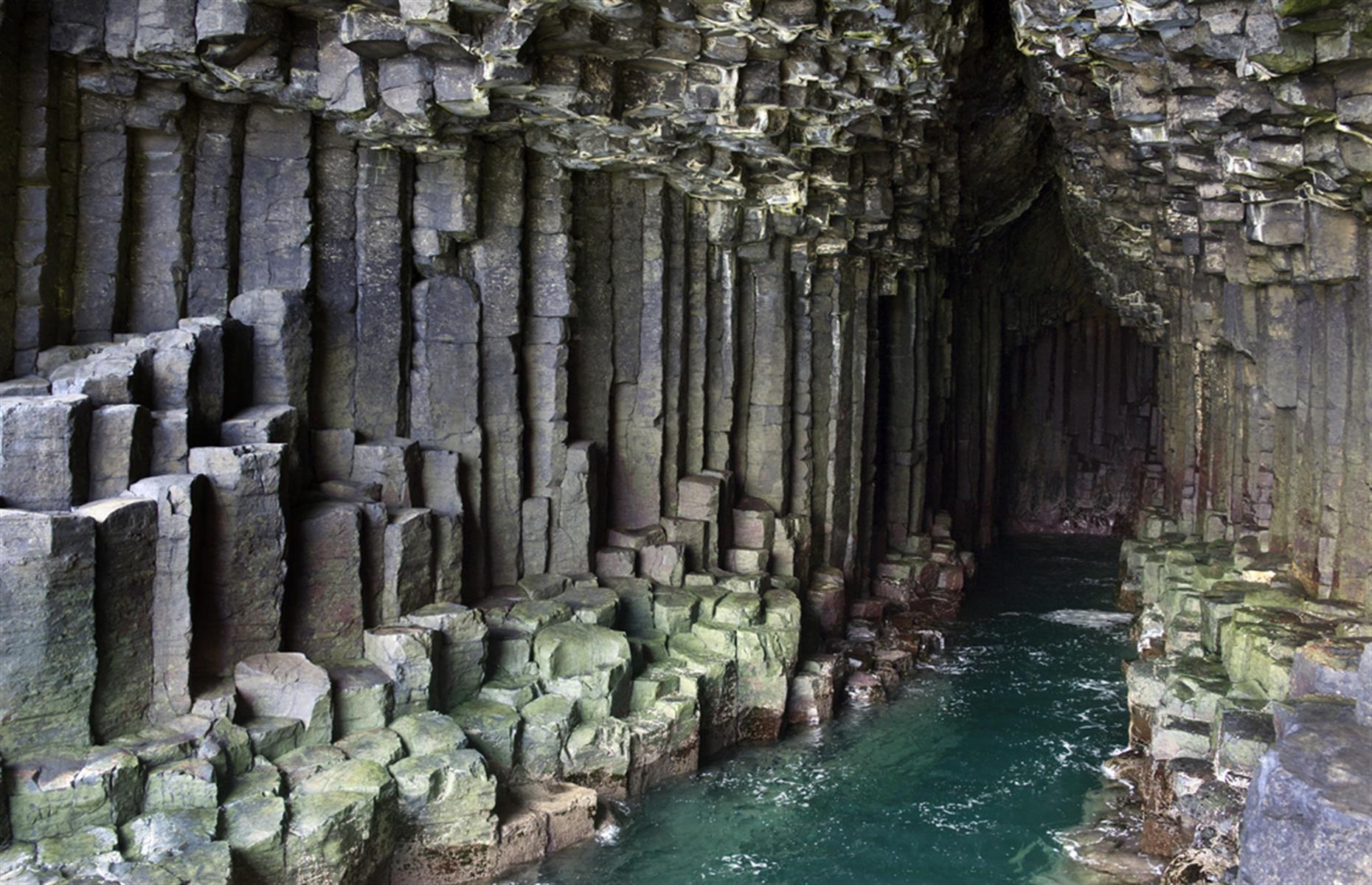 Fingal's Cave is a sea cave just off the coast of the Scottish island of Staffa. There's nowhere else in the world like it – Mendelssohn was moved to compose an overture inspired by it and Sir Walter Scott called it "extraordinary". The hexagonal formations are so regular that some people assume it was made by hand, but it's actually all natural. In good weather, tours run regularly from Oban, Iona and the Isle of Mull.