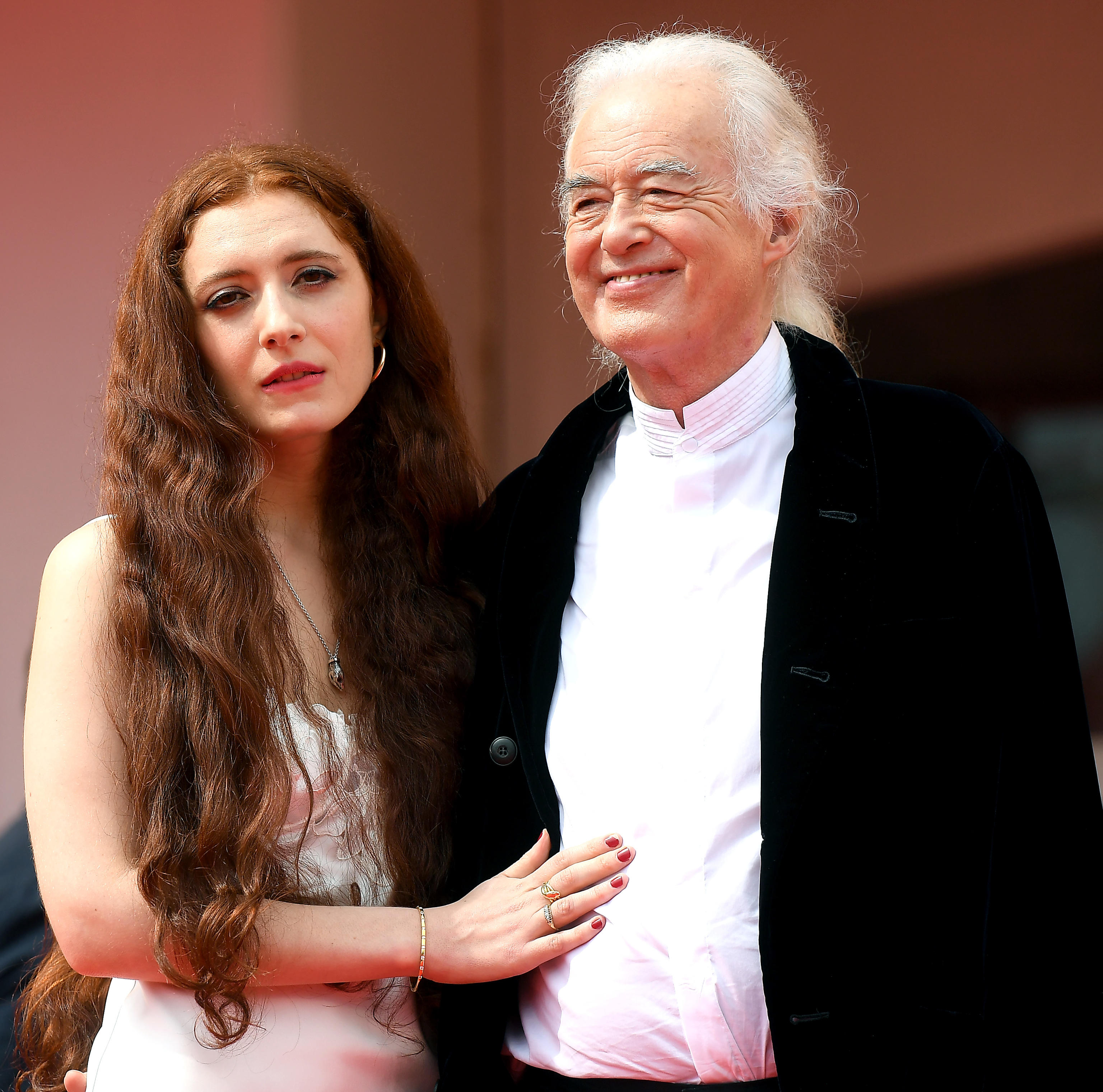 <p>Led Zeppelin guitarist Jimmy Page -- who turns 78 on Jan. 9, 2022 -- started dating Scarlett Sabet, who's 45 years his junior, after hearing her work at a poetry reading in a London bookshop in 2014. They've been together ever since: Scarlett, 32, is seen here with the rocker, then 77, at the <a href="https://www.wonderwall.com/celebrity/photos/venice-film-festival-2021-see-all-the-movie-stars-at-the-festival-491764.gallery">Venice Film Festival</a> in September 2021. "It's funny because on paper there is a massive difference. But when he's standing in front of me, it's not something I feel. It's not something that impedes us," the poet told Tatler in 2020. "I guess some people will say I've made an unusual choice. At the time it felt very uncomfortable. I felt like my life was going to be over. I had such a sense of shame about the whole thing." However, she added, "I'm in an amazing relationship. I think a lot of people make assumptions but Jimmy's an exceptional man, and beautiful. There are a lot of women of all ages who are excited to meet him. And I feel lucky, he really is my best friend and the person who makes me laugh the most."</p>