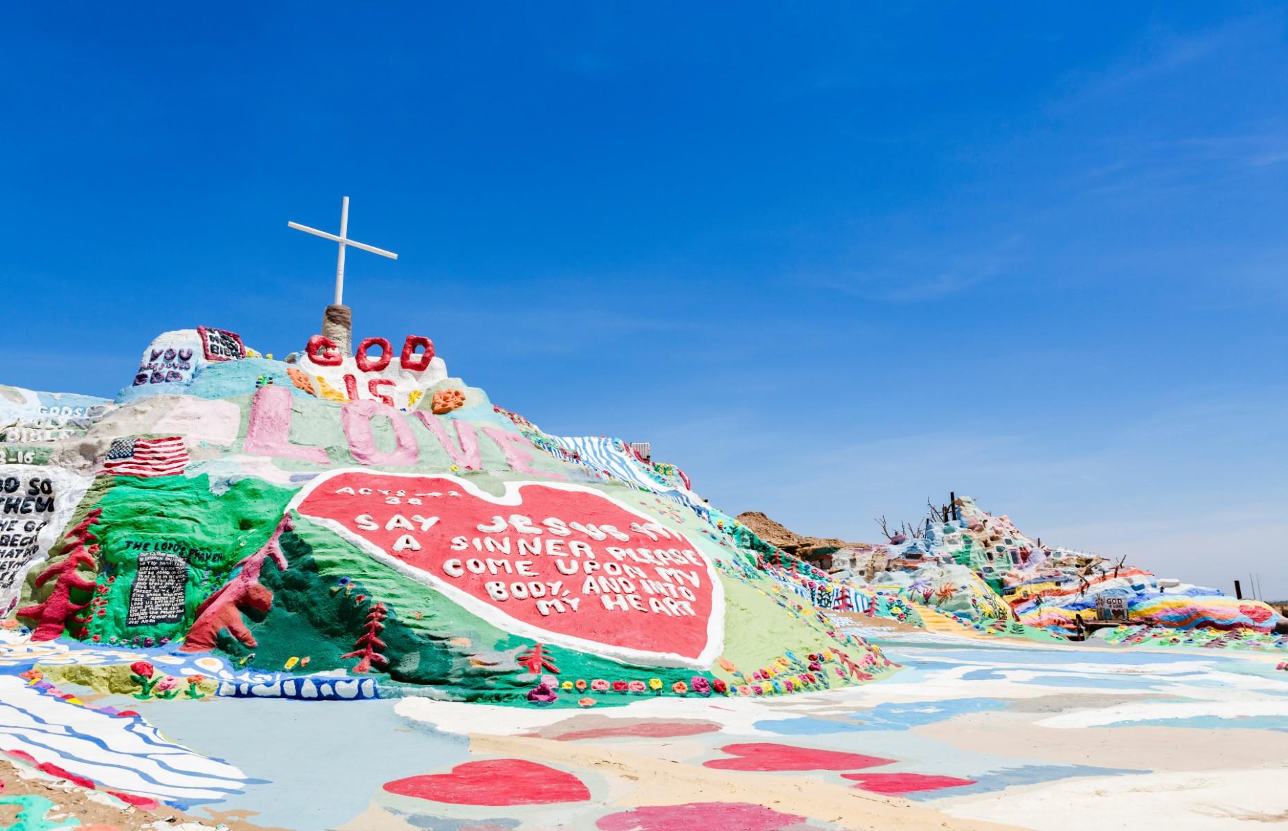 <p>Local adobe clay, straw, thousands of gallons of donated paint and a lot of love were poured into creating <a href="https://www.salvationmountain.us/">Salvation Mountain</a>, a vivid hillside monument in California’s Colorado Desert, near Calipatria in southern California. It was created by local artist Leonard Knight, who began piecing it together in 1985 as a symbol of his religious devotion. He regularly updated it with messages and embellishments up until his death in 2014.</p>