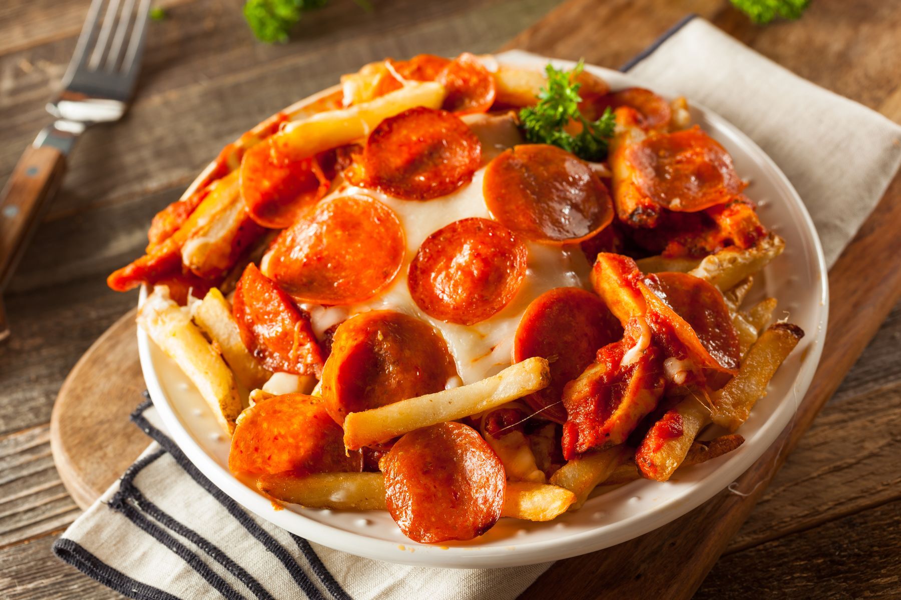 <p>Build your next <a href="https://www.domestically-speaking.com/pizza-fries/">pizza on a bed of fries</a> rather than on a traditional crust. You’ll need a fork and knife to eat, though!</p>