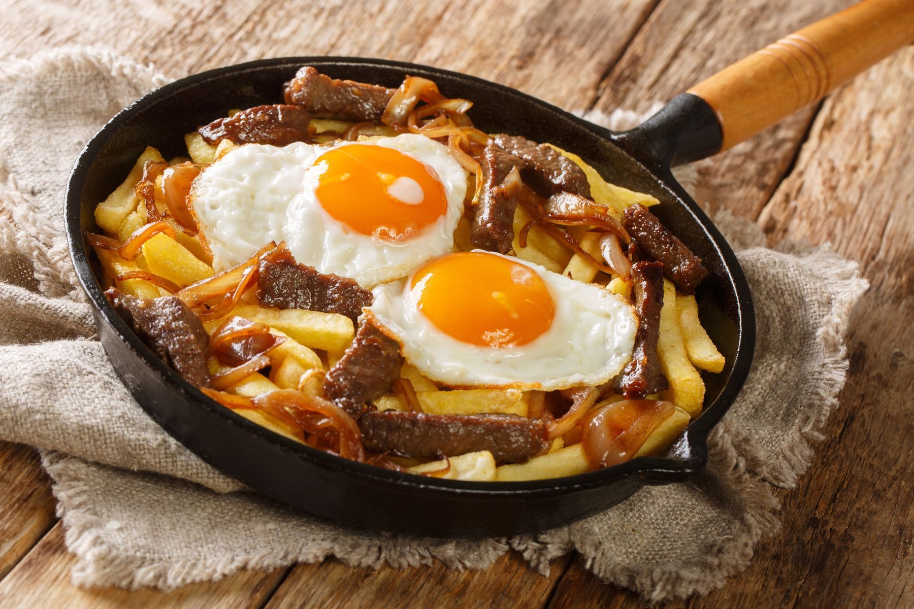 <p><a href="https://blog.amigofoods.com/index.php/chilean-foods/chorrillana/">Chorrillana is to Chile</a> what poutine is to Quebec. Sliced meat, caramelized onions, and fried eggs top a mountain of fresh fries.</p>