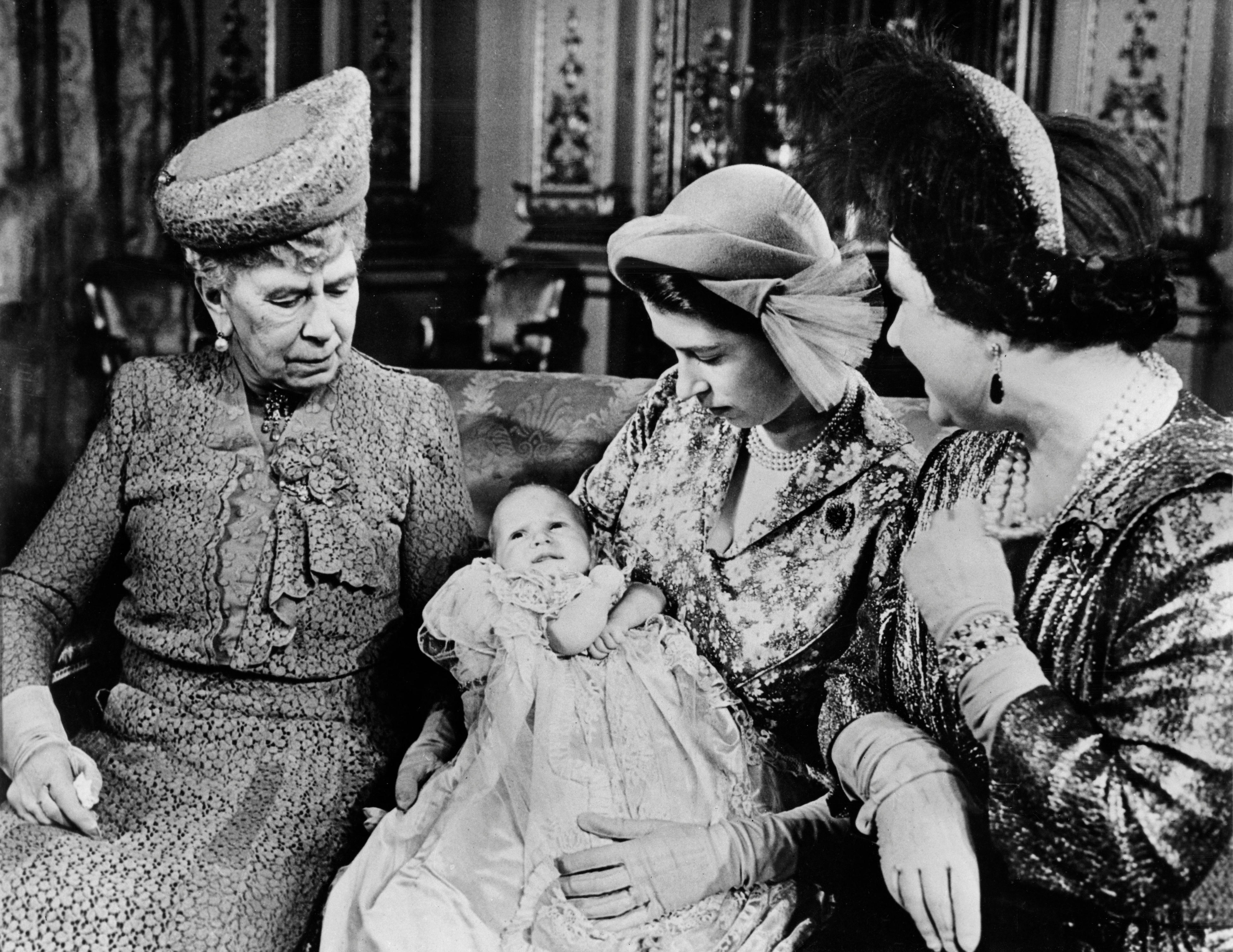 <p>Princess Elizabeth (later Queen Elizabeth II) cradled her second child, daughter Princess Anne, as grandmother Queen Mary and mother Queen Elizabeth the Queen Mother looked on at Anne's christening in October 1950.</p>