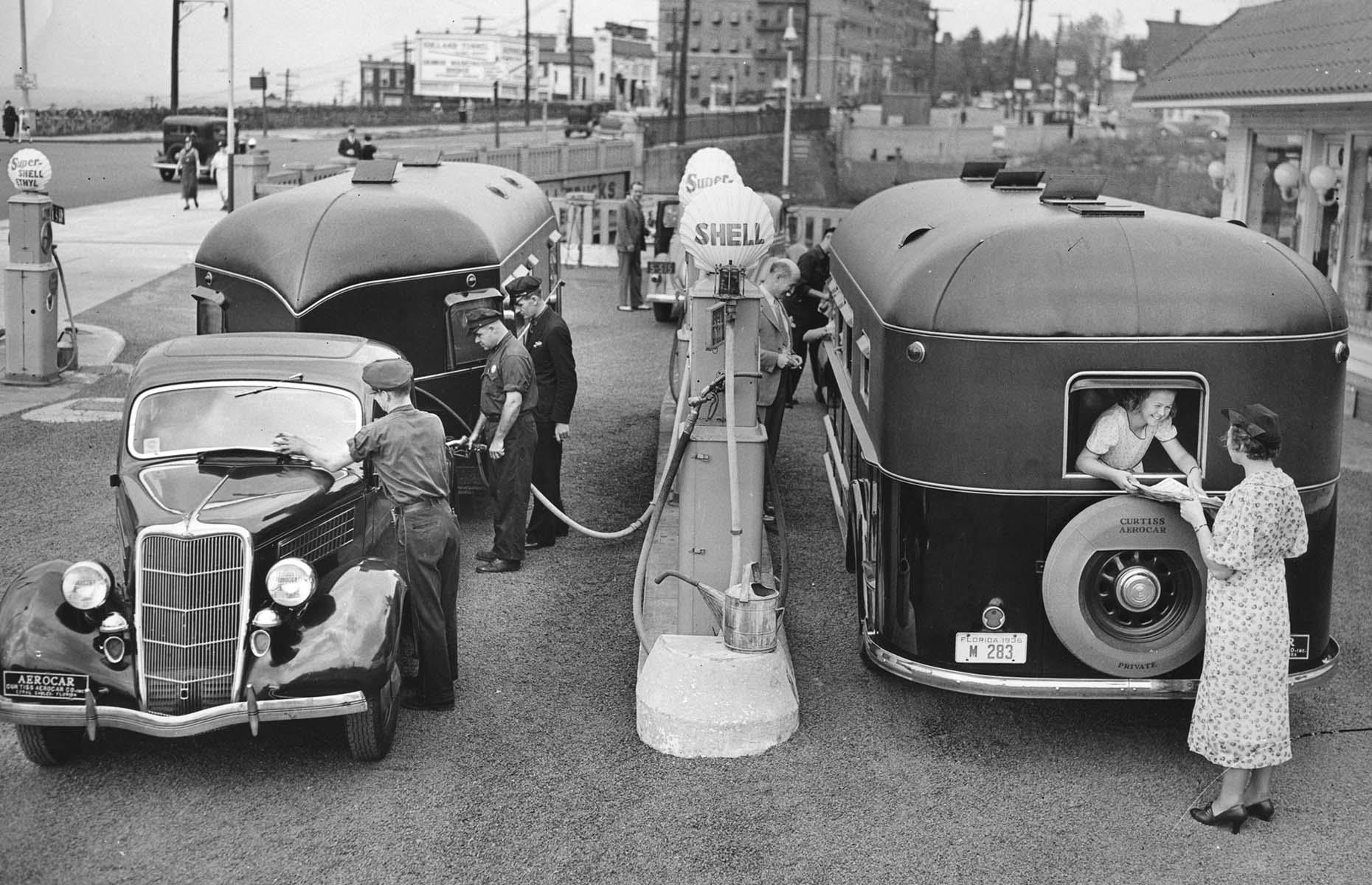 Through the 1930s, the Great Depression slowed the pace of America's automobile boom – but you'd still spot newfangled trailers, touring cars or makeshift RVs on US highways. Here a pair of gleaming vehicles pulling Curtiss Aerocars fill up at a gas station in New Jersey.