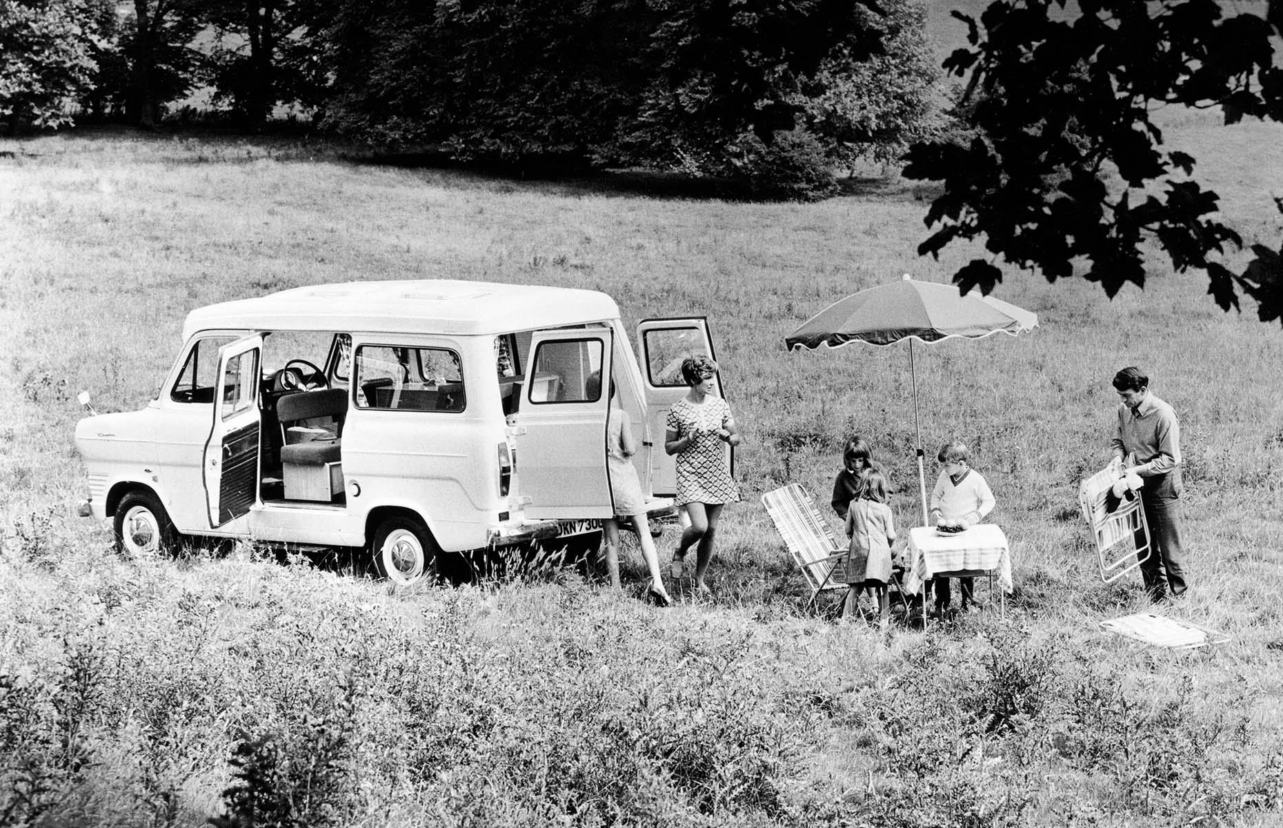 However, some people still eschewed organized campgrounds in favor of parking up in their own peaceful pocket of America. This idyllic scene shows a family with a converted Ford Explorer camper van setting up for a picnic in a quiet meadow.