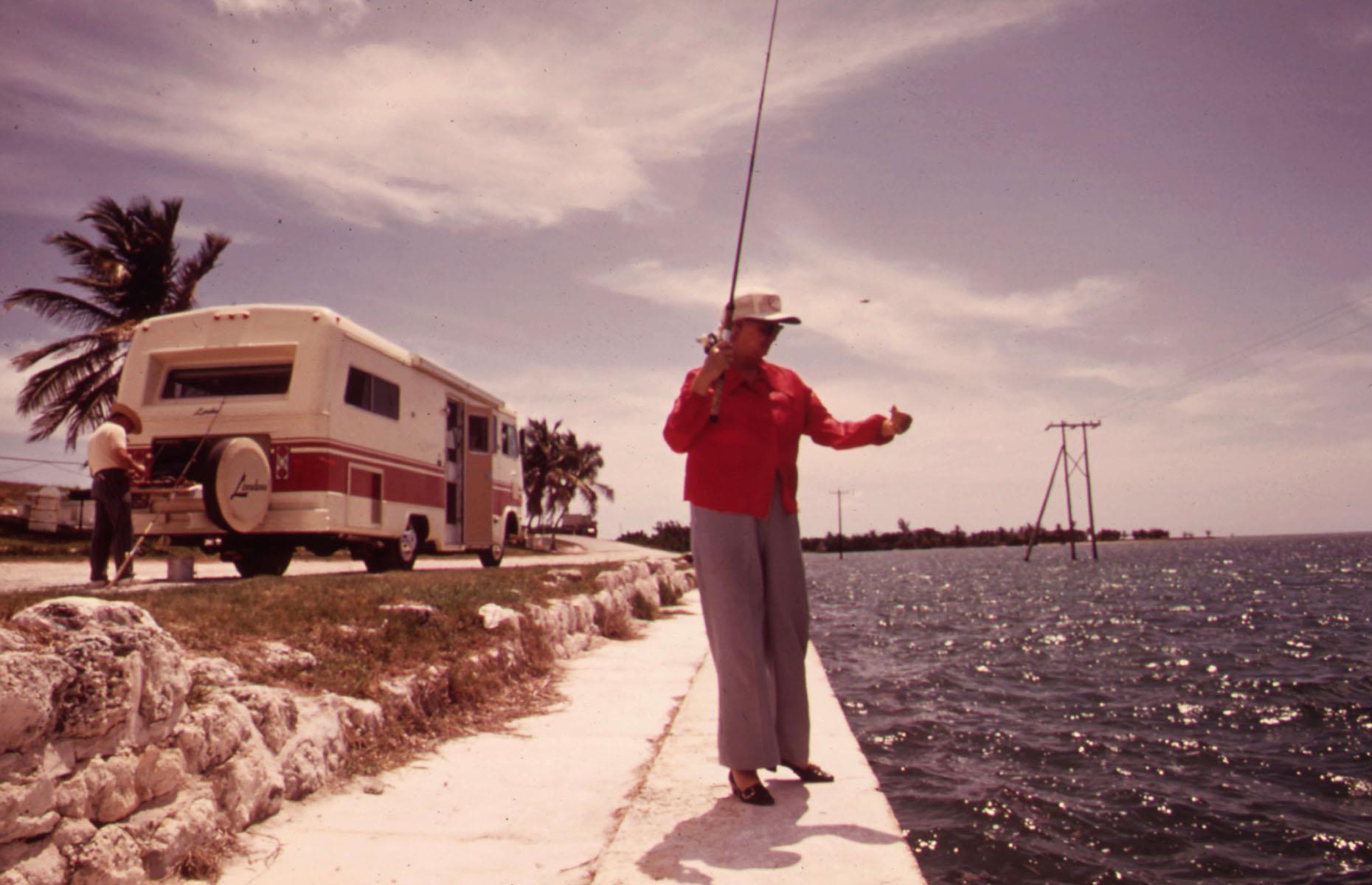 While newfangled motorhomes and ever-improving highways opened up the whole of America to travelers, the Sunshine State remained an enduring favorite with vacationers. Here, a retired couple from California stop off in Florida's Spanish Harbor Key for a spot of fishing. Their RV glints in the sunshine at the water's edge.