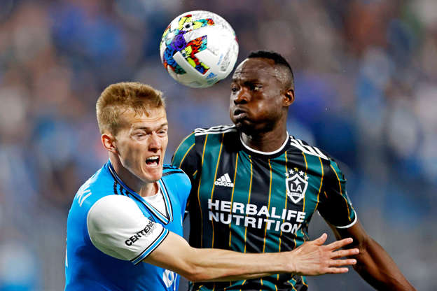 Slide 2 of 9: March 5: Charlotte FC's Karol Swiderski (left) and Los Angeles Galaxy's Sega Coulibaly go for the ball during the first half at Bank of America Stadium. The LA Galaxy won the game, 1-0.