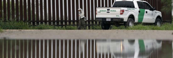 A U.S. Customs and Border Patrol agent passes birdwatcher Nancy Hill, 81, along a section of the border wall Sunday, Nov. 13, 2016, in Hidago, Texas.