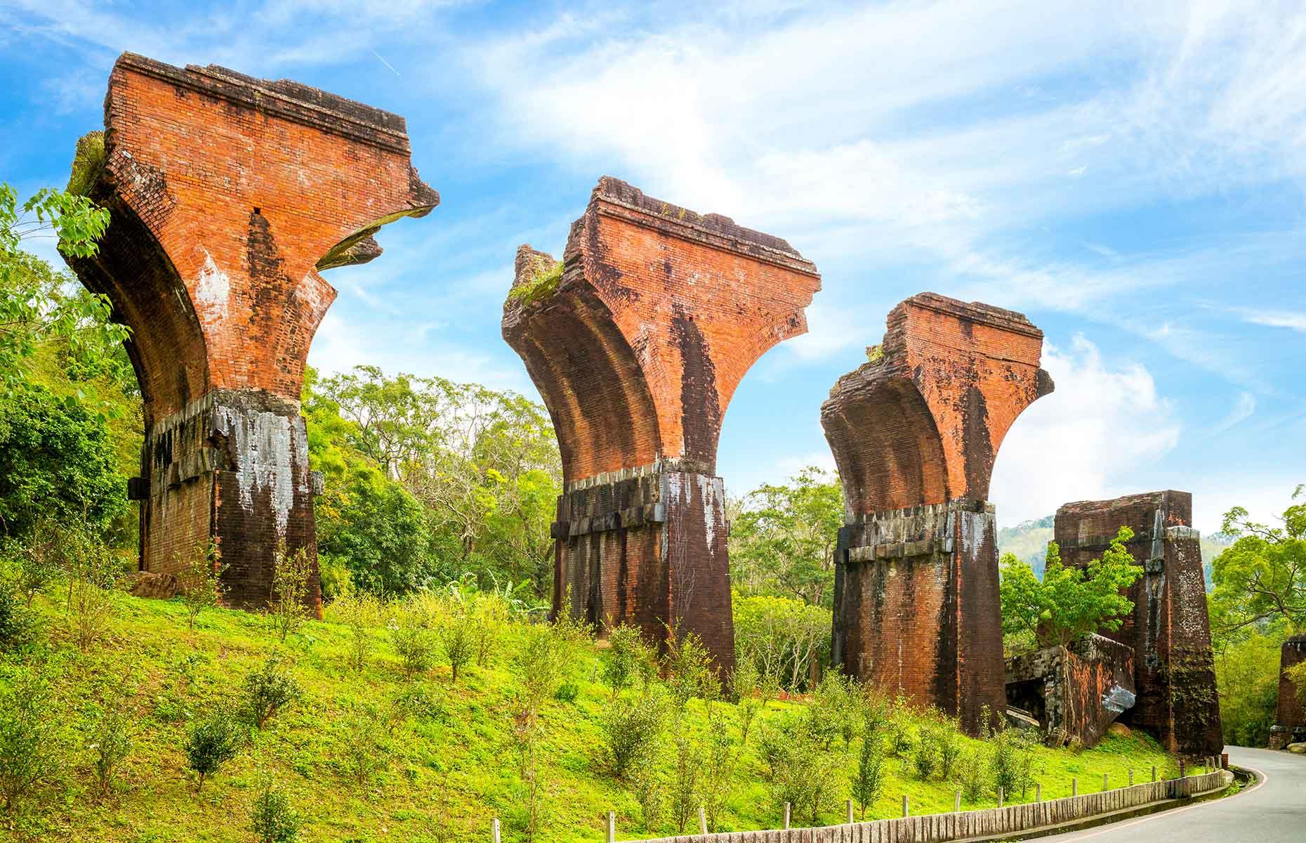 <p>The remains of Longteng Bridge are a strong reminder of the power of Mother Nature. When the bridge was first built in 1905, the workers used glutinous rice instead of cement to hold the bricks together. An earthquake in 1935 damaged the 164-foot-high (50m) bridge beyond repair and a second steel replacement was built beside it. The latter was then damaged too by a second earthquake in 1999. Still, at least there’s a silver lining: today it’s a popular tourist sight and wedding photography hot spot.</p>