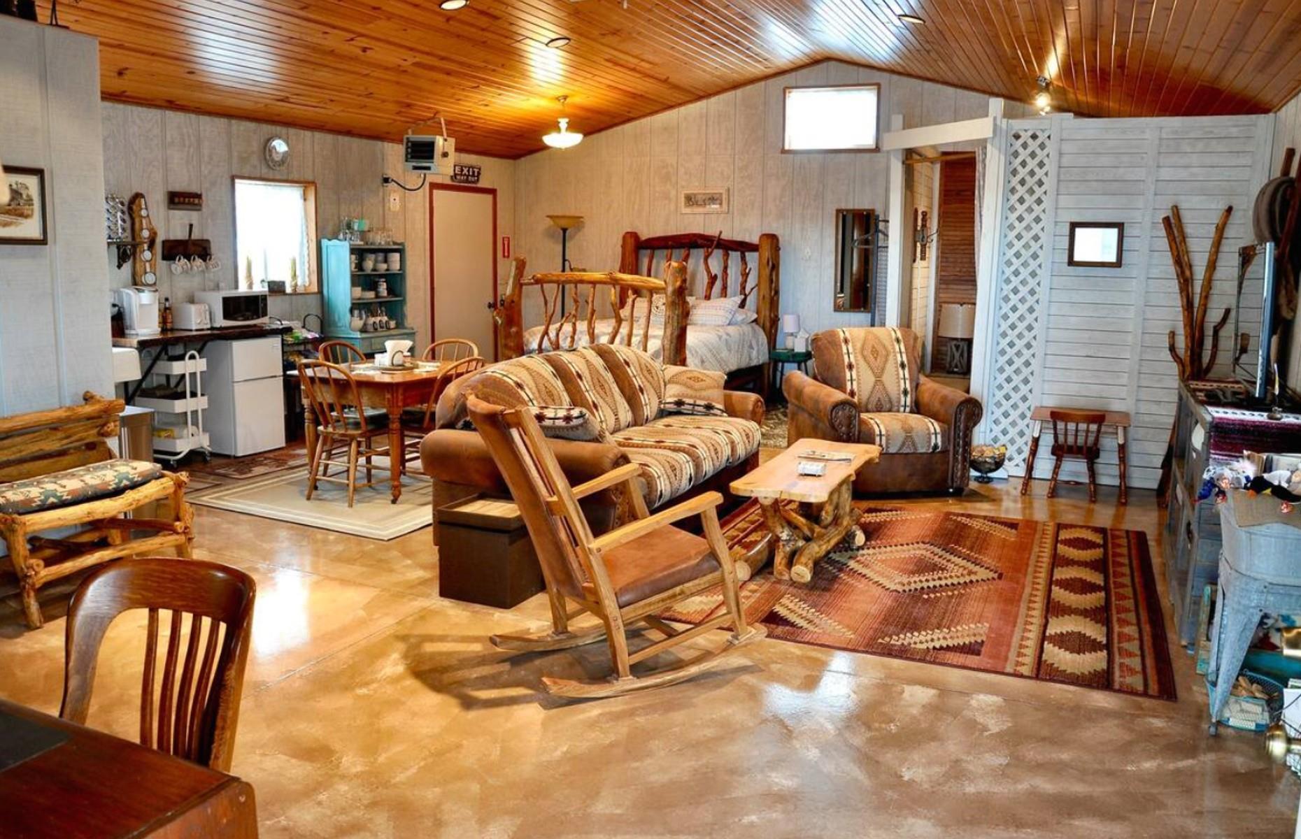 <p>To describe <a href="https://www.airbnb.co.uk/rooms/41129241">this guesthouse</a> as cozy would be something of an understatement. The open-plan space is all homely, rustic charm, from the squidgy leather seats and the handmade log bed to the front porch. It sleeps up to six people with a sofa bed and sleeping nook, so it’s one for a close family or group of friends and would equally make a perfect base for a couple. The home, which is close to the Black Hills and attractions including Mount Rushmore, is on Airbnb for around $95 a night.</p>