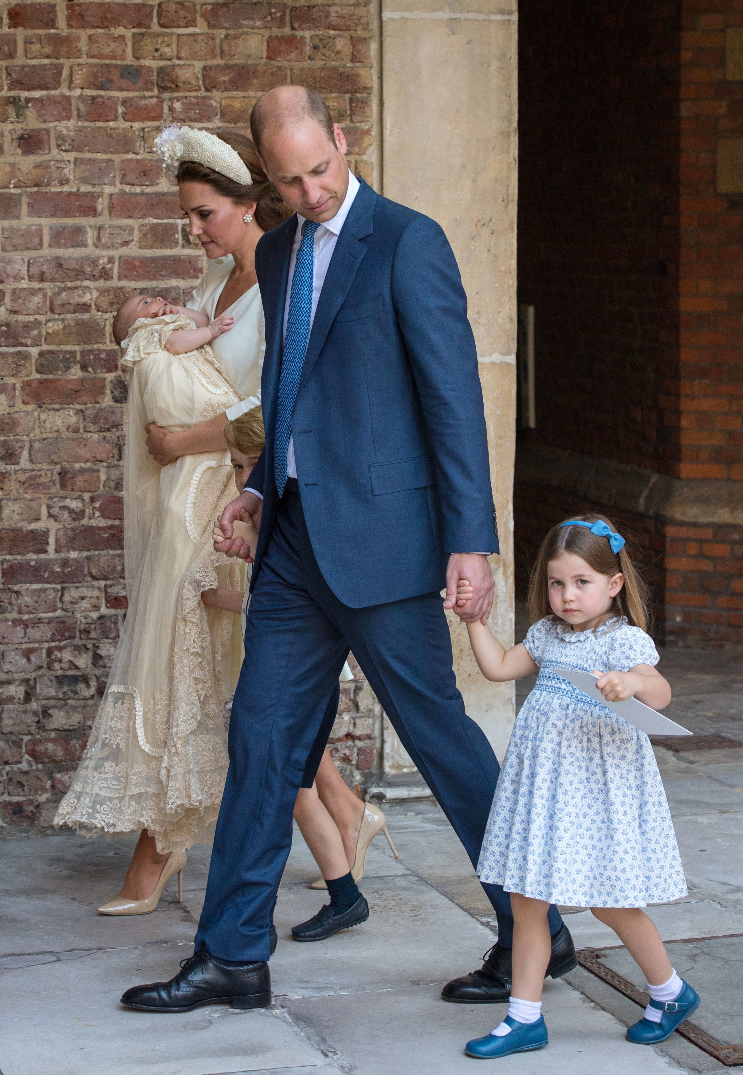 <p><a href="https://www.wonderwall.com/celebrity/profiles/overview/duchess-kate-1356.article">Duchess Kate</a> carried Prince Louis while Princess Charlotte held dad <a href="https://www.wonderwall.com/celebrity/profiles/overview/prince-william-482.article">Prince William</a>'s hand as they exited the Chapel Royal at St. James's Palace in London on July 9, 2018, following <a href="https://www.wonderwall.com/celebrity/photos/prince-louis-christening-all-best-photos-prince-william-duchess-kate-george-charlotte-prince-harry-meghan-royal-family-3015256.gallery">Louis' christening</a>.</p>