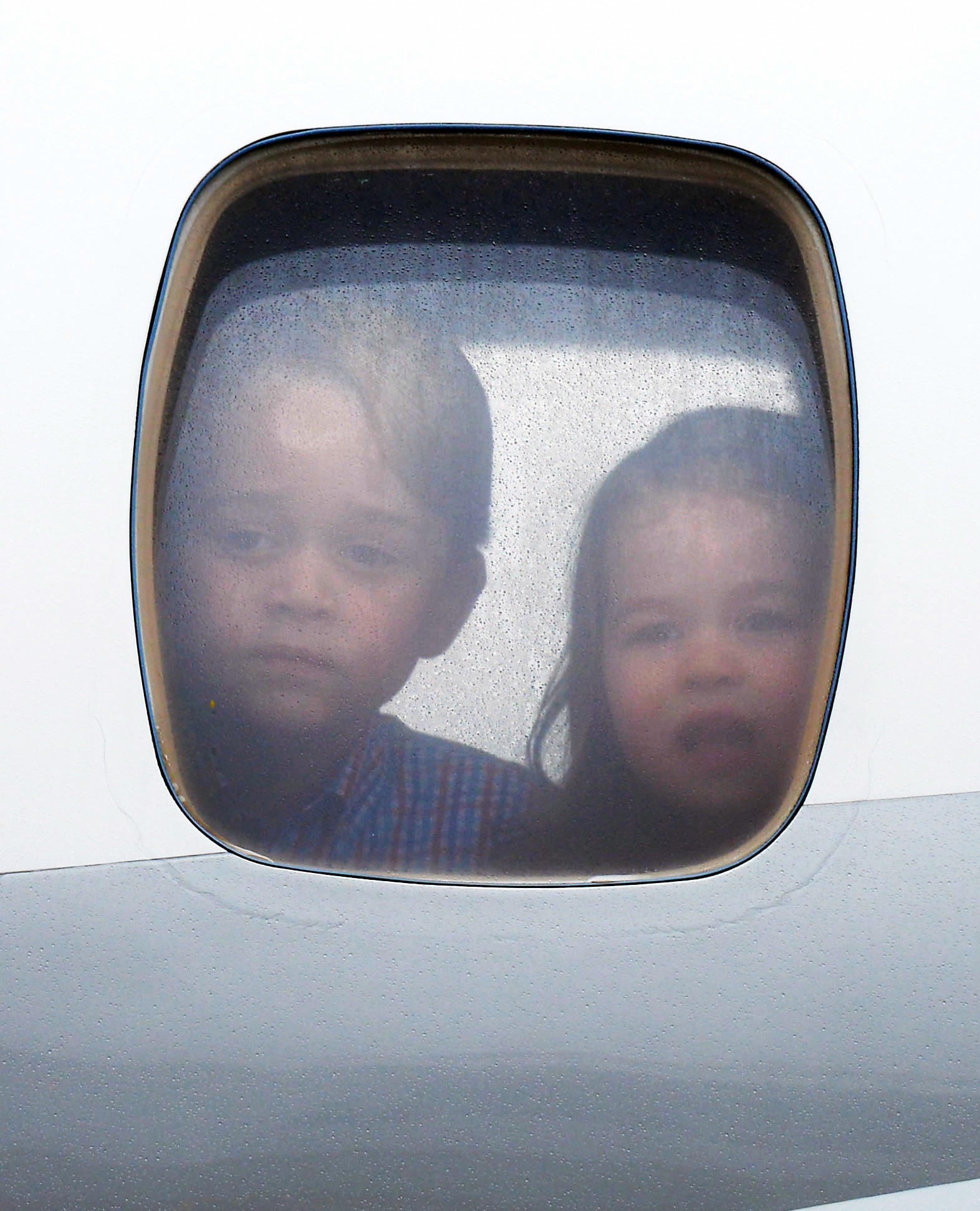 <p>Prince George and Princess Charlotte looked out the window of their Royal Air Force plane as they arrived in Warsaw, Poland, on July 17, 2017.</p>