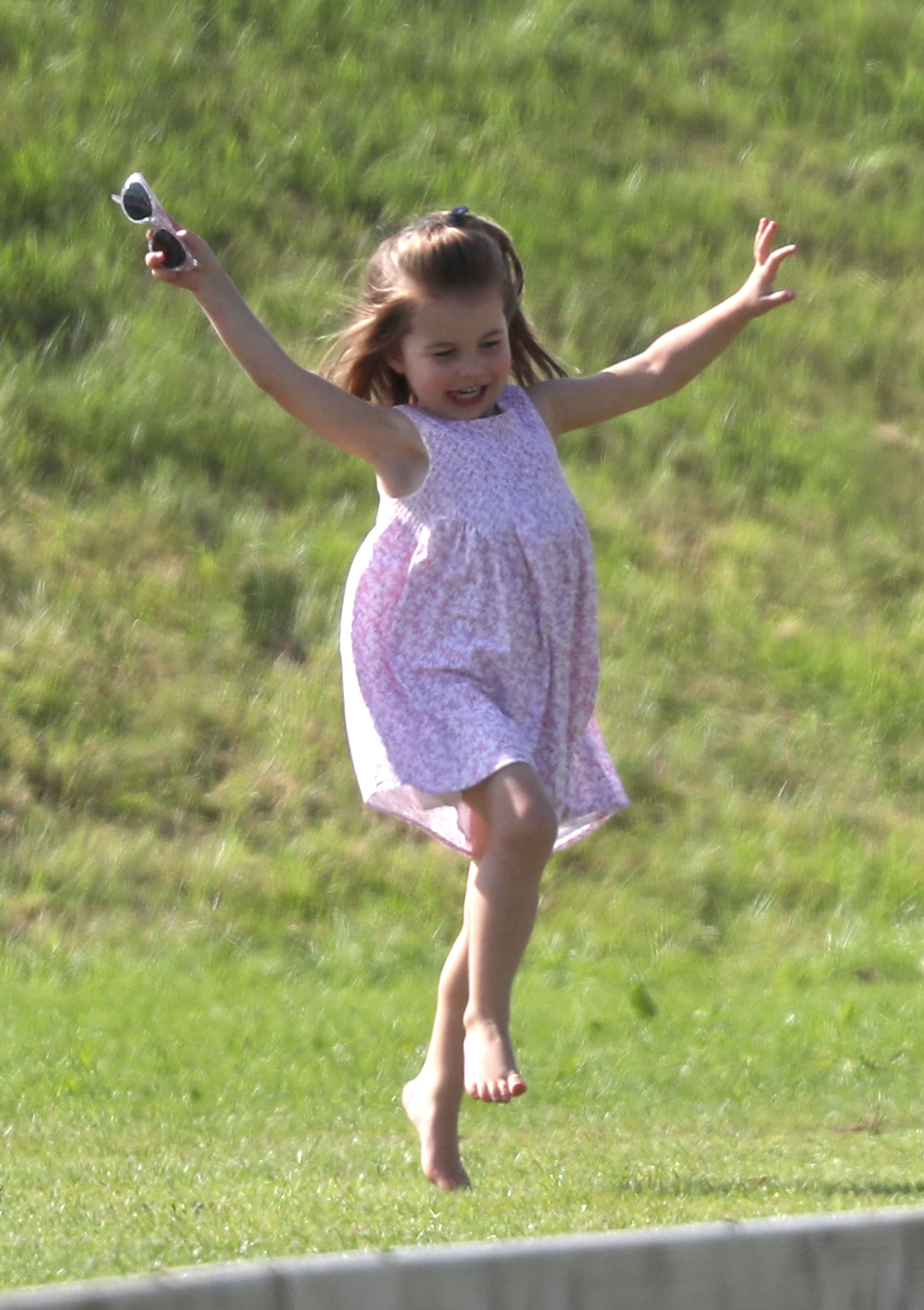 <p>Free as a bird! Princess Charlotte frolicked in the grass as her father, <a href="https://www.wonderwall.com/celebrity/profiles/overview/prince-william-482.article">Prince William</a>, played in the Maserati Royal Charity Polo Trophy match at Beaufort Park in Gloucester, England, on June 10, 2018.</p>