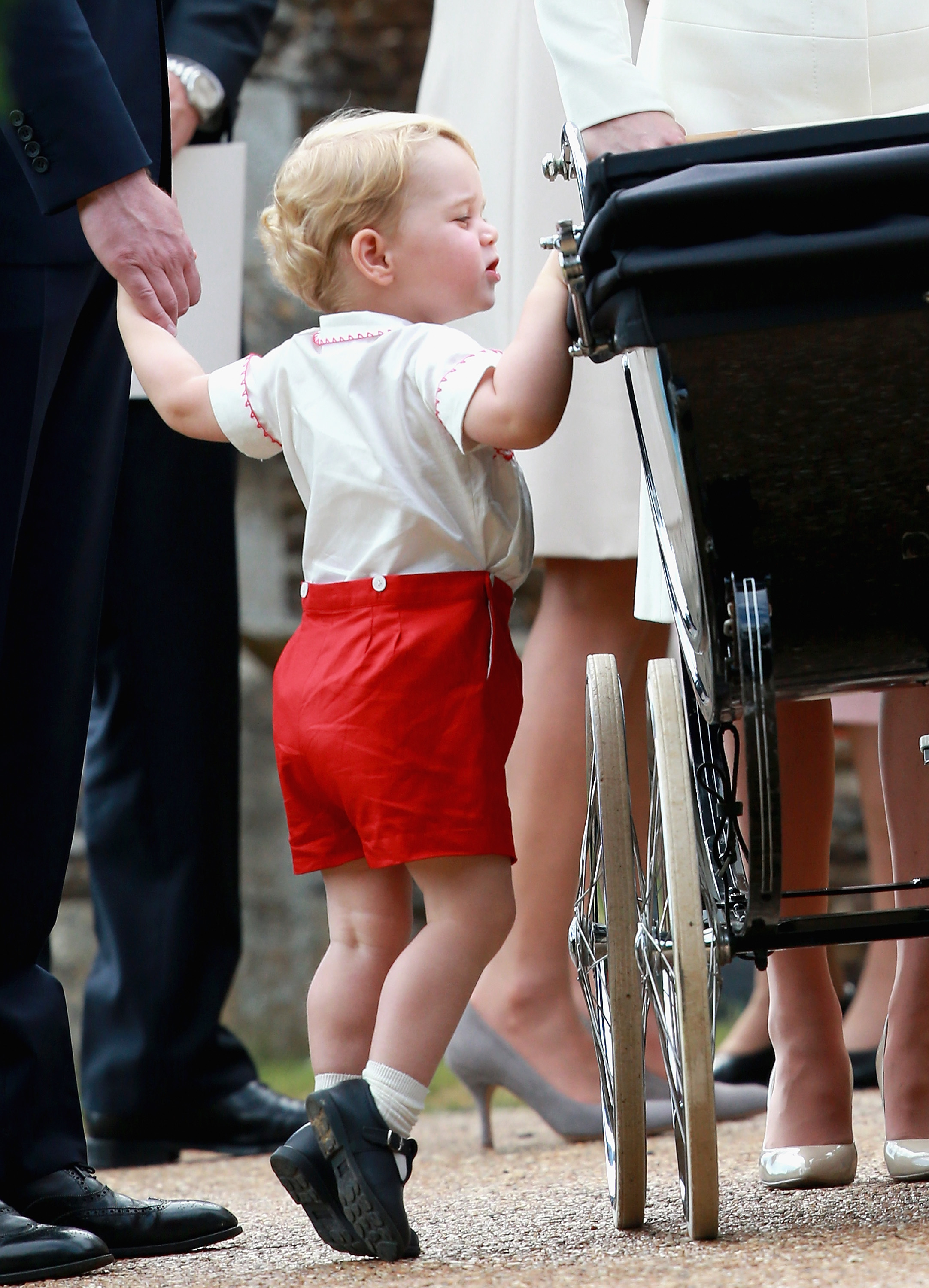 <p>Prince George stood on tippy toes to look at sister Princess Charlotte in her pram after her christening at the Church of St. Mary Magdalene on the queen's Sandringham Estate in King's Lynn, England, on July 5, 2015.</p>