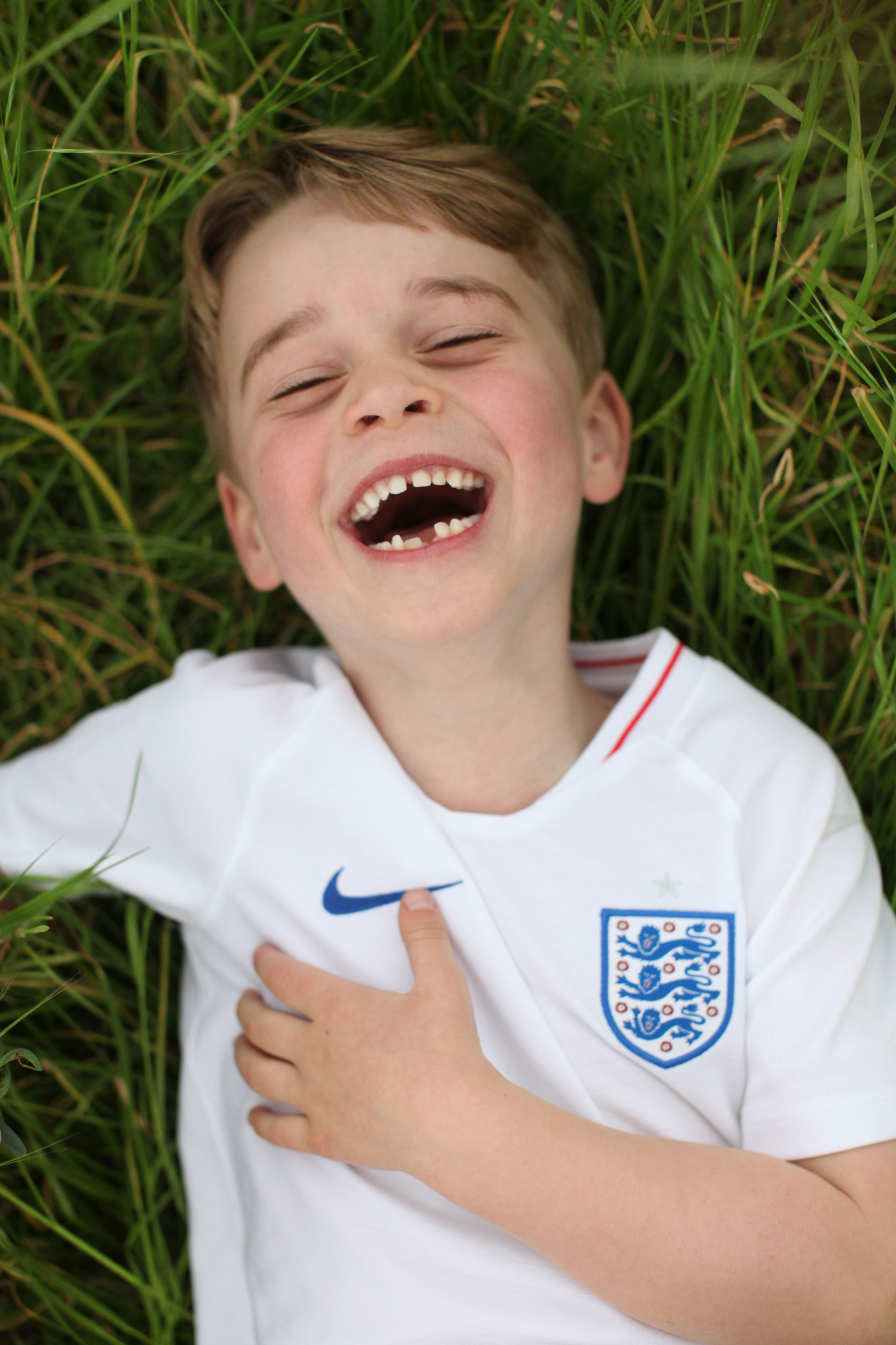 <p>Prince George is seen laughing in a photo taken by his mother in the garden at Kensington Palace to celebrate his 6th birthday on July 22, 2019.</p>