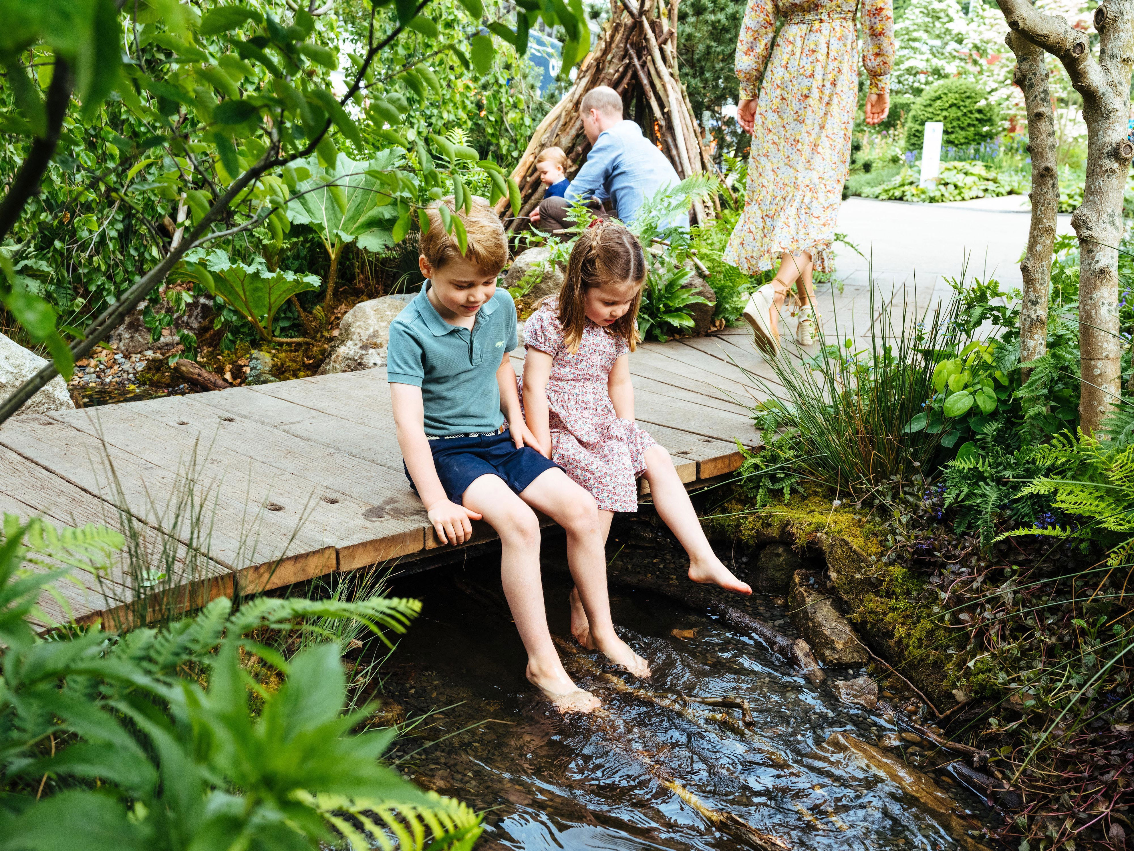 <p>Prince George and Princess Charlotte swung their legs over a brook as they explored the garden mom <a href="https://www.wonderwall.com/celebrity/profiles/overview/duchess-kate-1356.article">Duchess Kate</a> co-designed with Adam White and Andree Davies for the RHS Chelsea Flower Show in London on May 19, 2019.</p>