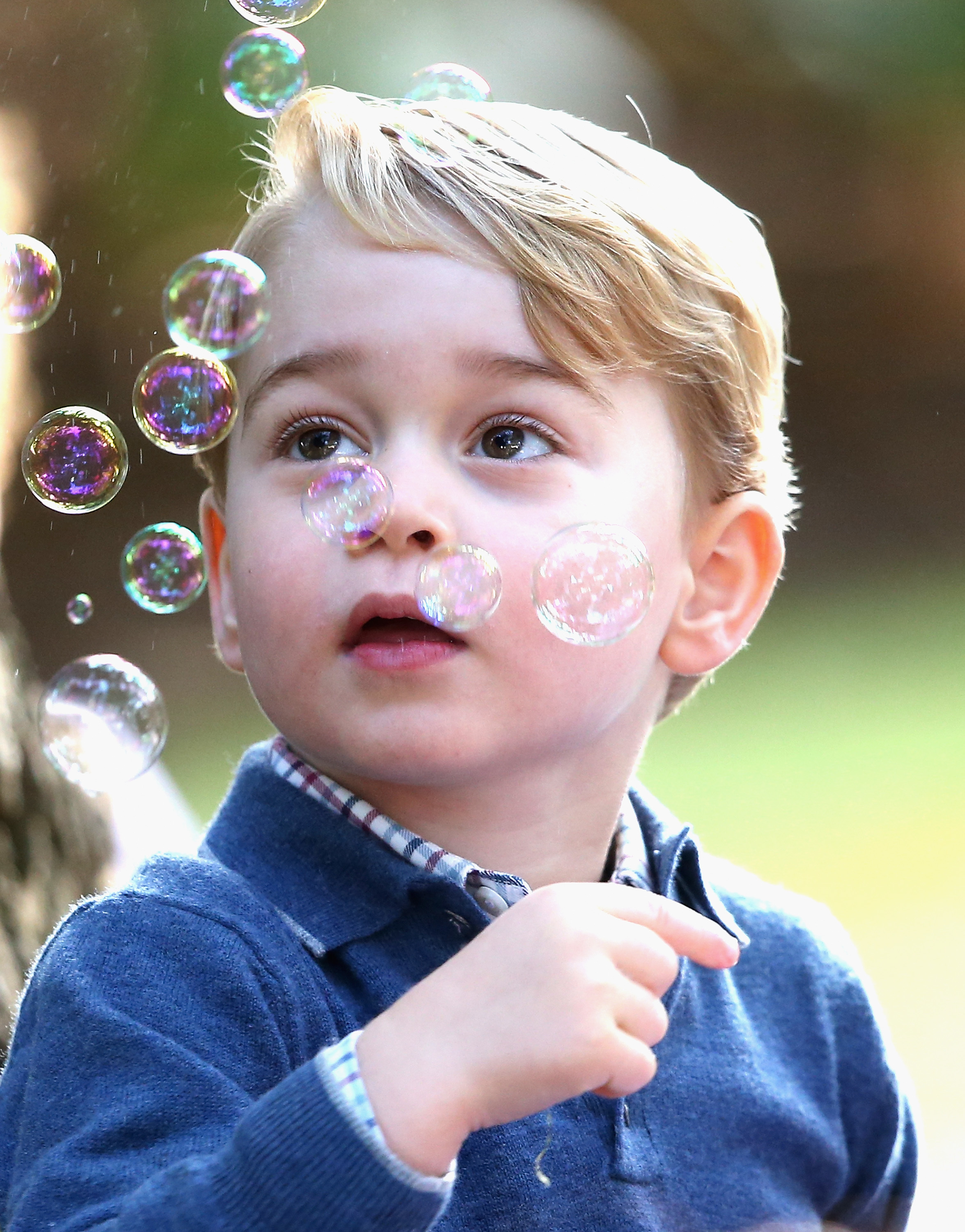 <p>Prince George blew bubbles at a children's party for military families during his family's royal tour of Canada in Victoria on Sept. 29, 2016.</p>