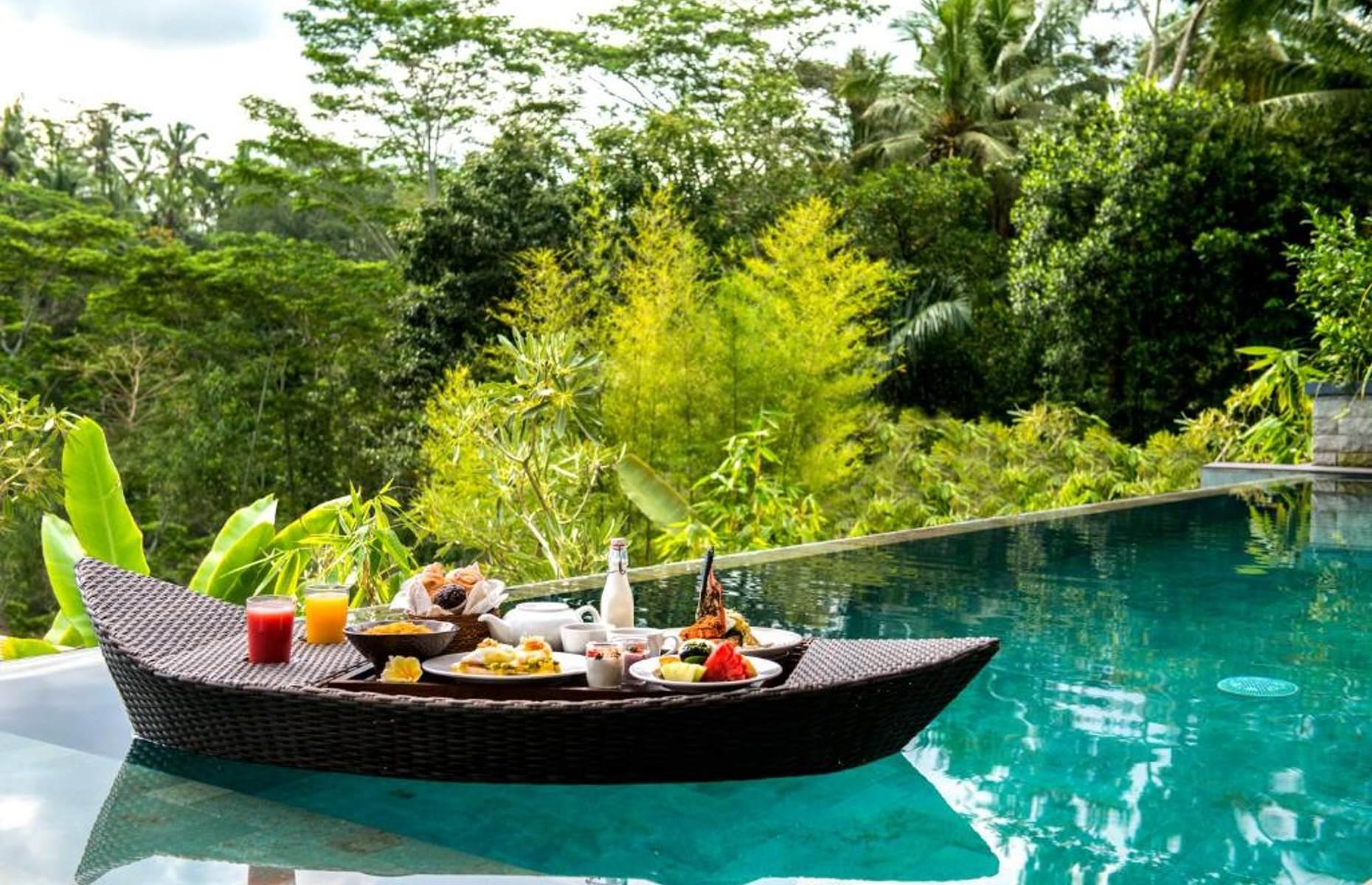 <p>Bali is the motherland of the famous floating breakfast, where pool-dwellers can indulge in a delicious morning spread without even having to reach for their towel. The <a href="https://www.booking.com/hotel/id/samsara-ubud.en-gb.html?label=gen173nr-1DCAsoaEIMc2Ftc2FyYS11YnVkSDNYBGhQiAEBmAEJuAEXyAEM2AED6AEB-AECiAIBqAIDuAKrruaRBsACAdICJDVmMzA0ZjQzLWRjMmItNDg0OS1iYWZjLWFhNGI0MTRiMTdlN9gCBOACAQ;sid=6bd457d89898c64402b235d297ce50ac;dist=0&group_adults=2&group_children=0&keep_landing=1&no_rooms=1&sb_price_type=total&type=total&">Samsara Ubud</a> presents theirs in a crescent-shaped boat filled with sweet pastries, cakes, fresh jungle fruit and yogurt. Indonesian nasi uduk (steamed rice cooked in coconut milk), French toast and lobster eggs Benedict are also options. Those who prefer a static meal are more than welcome to dine at a table and breakfast is included with your villa booking.</p>
