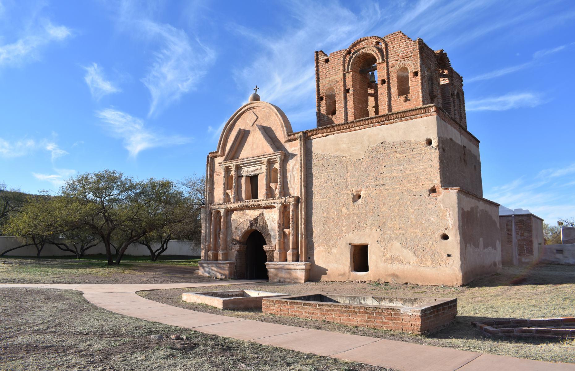 <p>To discover Arizona’s complex history, the Tumacácori National Historical Park is a good place to start. Situated in the Santa Cruz River Valley, around an hour south of Tucson, the site is home to one of the state’s earliest missions, the Mission San José de Tumacácori. First established by Spanish settlers in 1691, the present-day mission dates to the 1750s, although the building was never completed. It was built on land held by the O’odham people for thousands of years and became a site of conflict between Spanish and indigenous people. Today, you can visit the church and hike through the park.</p>