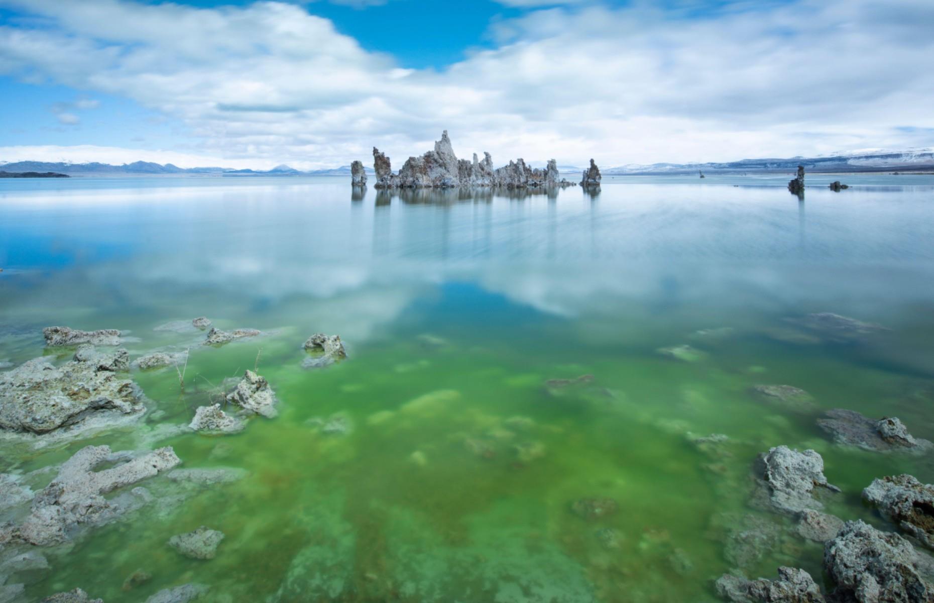<p>There are so many curiosities about California’s Mono Lake that it’s hard to know where to begin. For one, the 65-square-mile (168sq km) body of water is filled with hulking tufa towers which look like they've landed from Mars (they’re actually formed by underground springs). Another striking feature is its bright green hue. While it's know that this is a result of algal blooms, which reproduce due to the higher salt and alkaline levels that occur when the lake dries up, there’s still some mystery surrounding this process.</p>