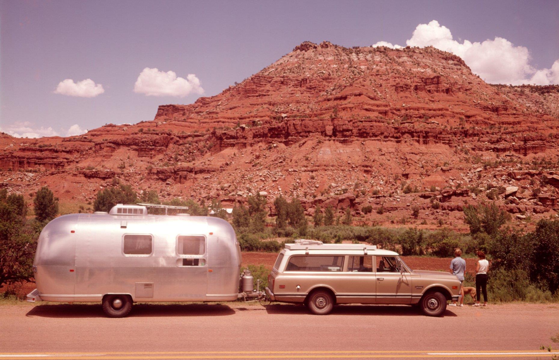 Trailer ownership waned in the late 1970s due to the recession and gas crisis, so much so that Airstream changed tack and released a motorhome for the first time. But its famous trailers remained in use. In this image from the decade, a couple gaze at New Mexico’s stunning mesa formations on a road trip, their Airstream attached to the back of a classic station wagon.