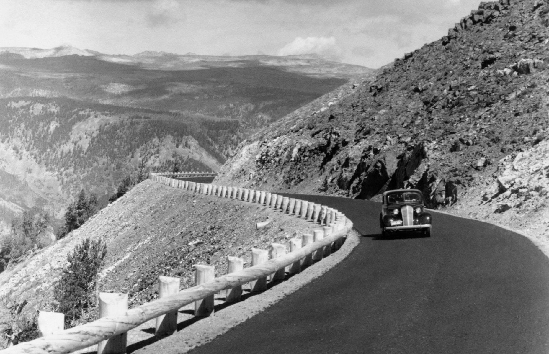 The national parks remained popular road trip destinations throughout the decade, as you can see from this black-and-white image of a car driving through Yellowstone in 1941. Parks’ infrastructure began to improve and families’ disposable income rose dramatically, making vacations more accessible for many too.