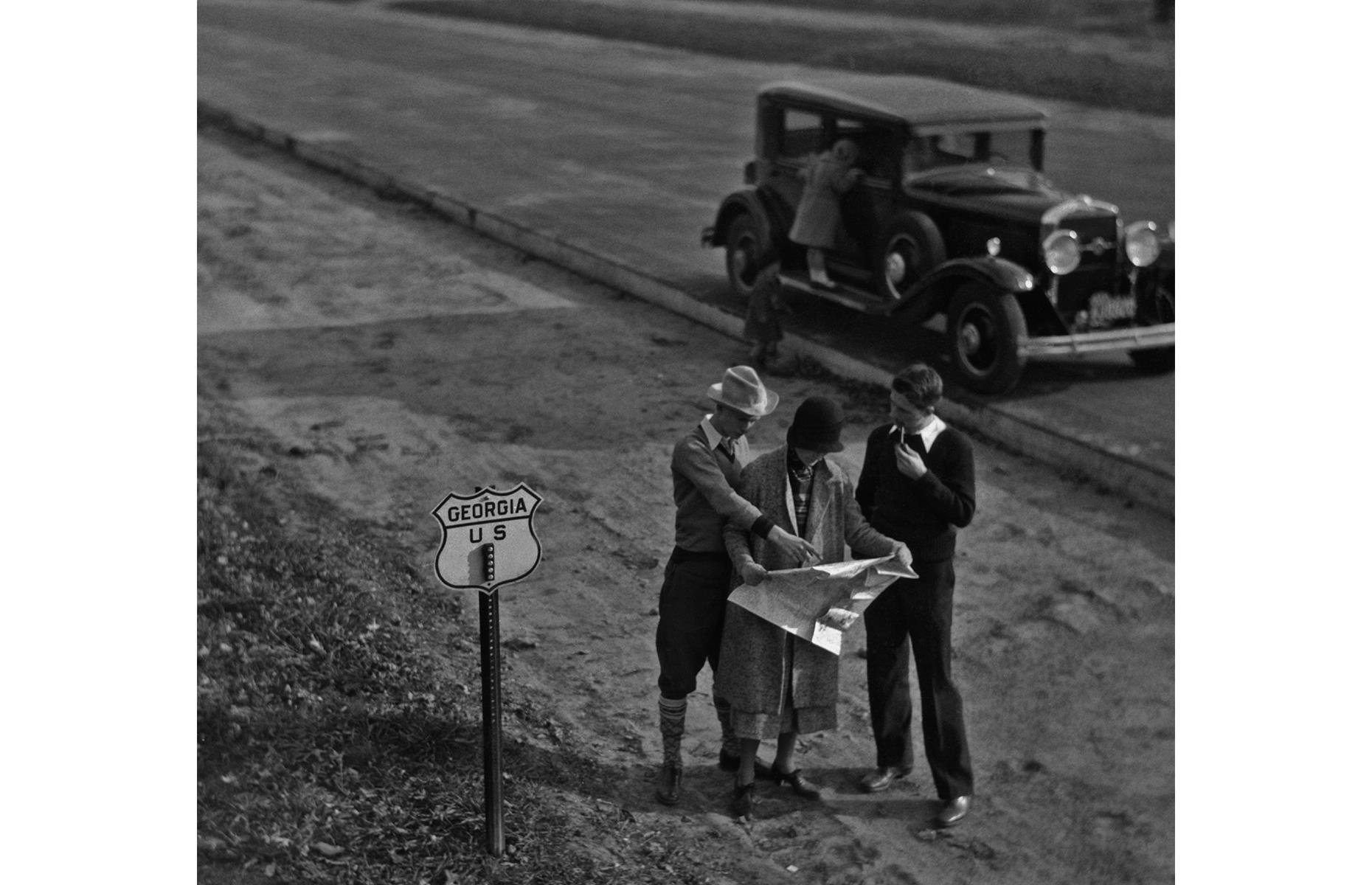 The Great Depression shook the automobile industry, and sales declined throughout this decade. However, those who could afford to still enjoyed the freedom of the open road, traveling to the coast, the mountains and beyond. Here, road trippers consult a map while passing through the state of Georgia.
