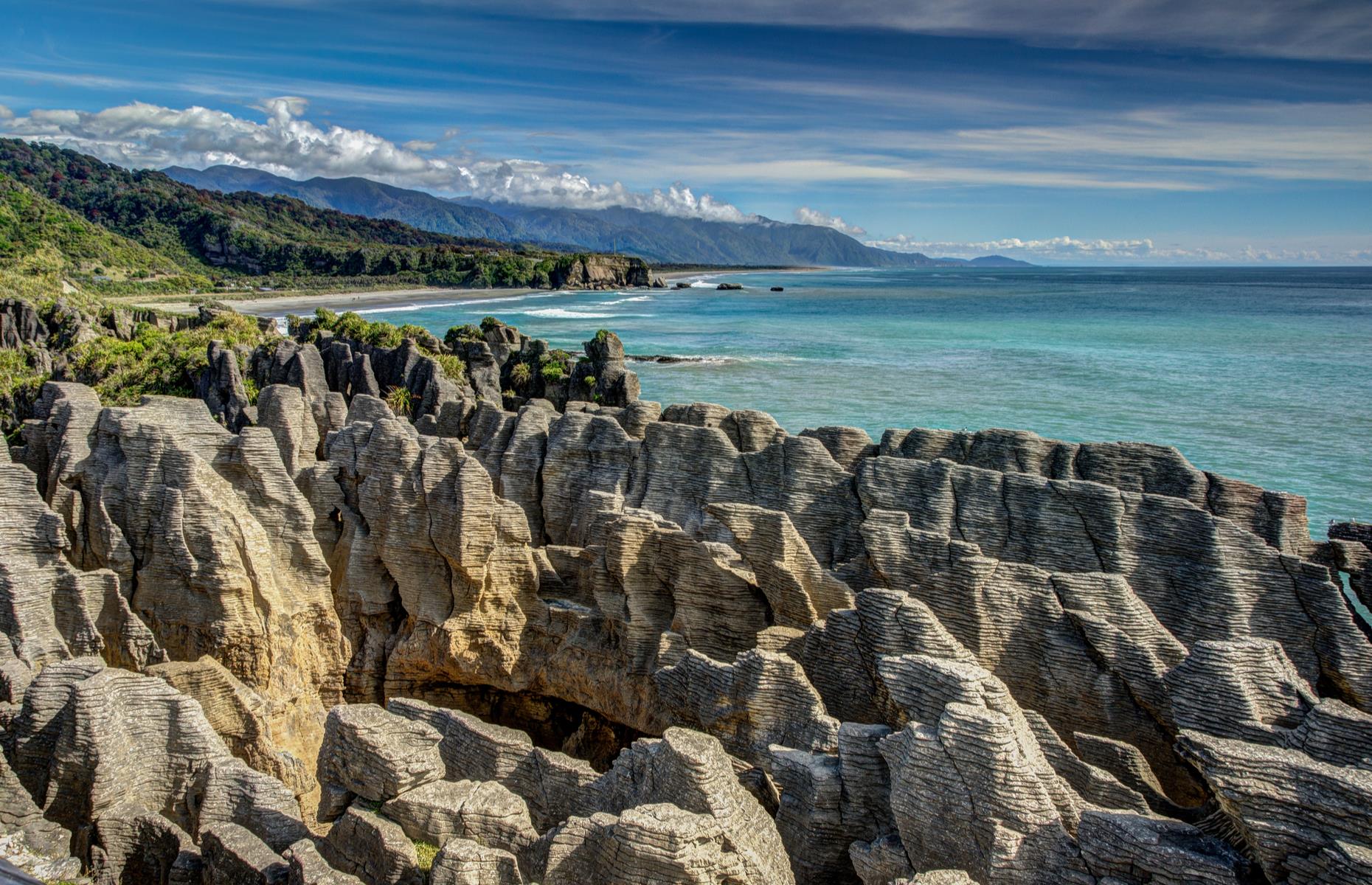 Around 30 million years in the making, the Pancake Rocks at Dolomite Point near Punakaiki are a heavily eroded limestone area with vertical blowholes (at their most impressive at high tide). The Pancake Rocks track can take around 40 minutes to walk, but you’re sure to be a lot longer as you stop to take photos of this incredible natural wonder.