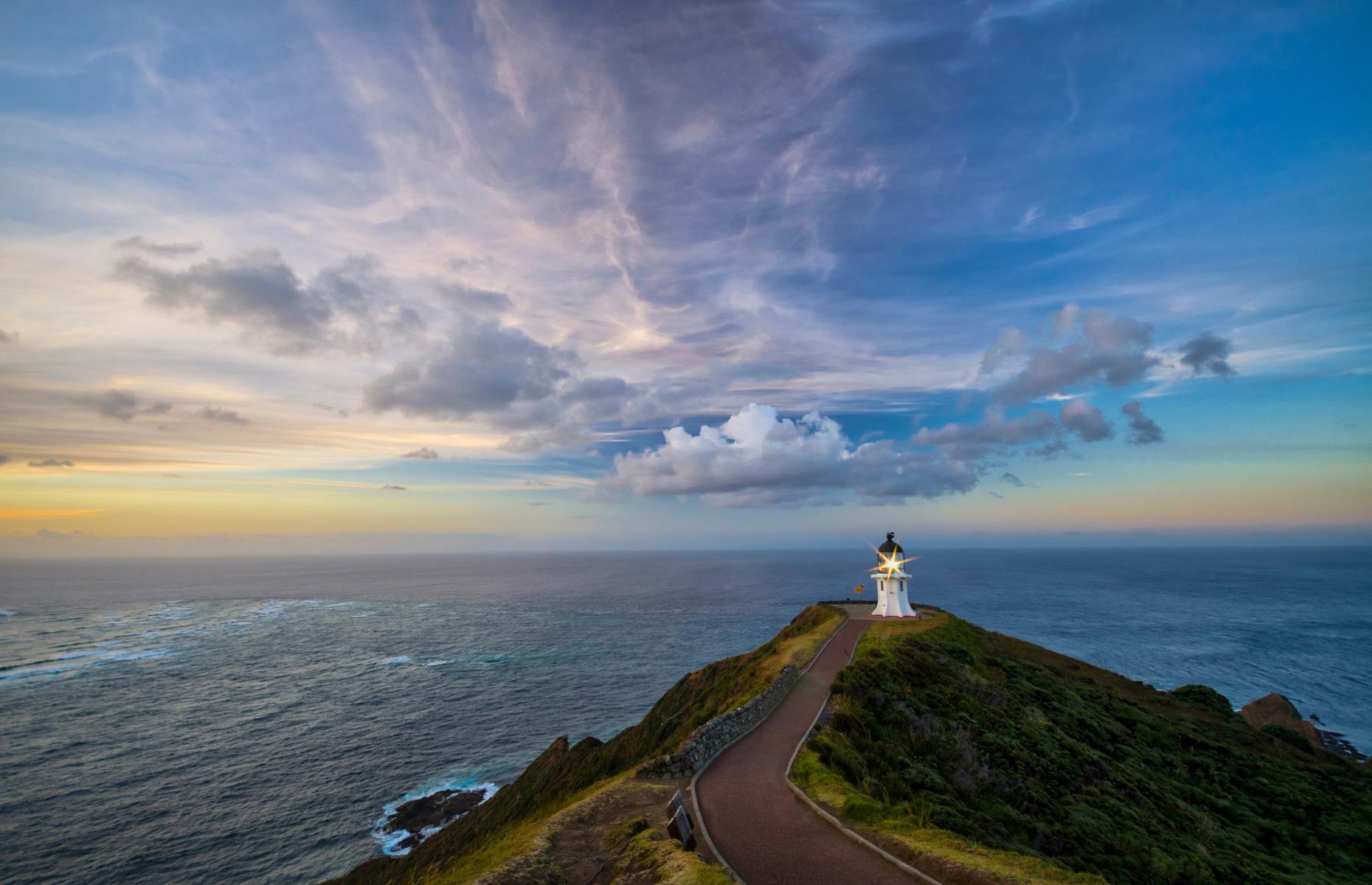<p>Standing at the lighthouse at the far north of New Zealand looking out at the Tasman Sea and the Pacific Ocean colliding, you can feel why it’s such a special place for Māori. <a href="https://www.newzealand.com/uk/cape-reinga/">This sacred site</a> at the end of the road marks the point from which Māori wairua (spirit) return to their traditional homeland. While it's not the most northern point of the country (North Cape is, but it's not open to public), this is as far as you can get by road. There are guided coach tours departing from Kaitaia and Paihia daily too.</p>