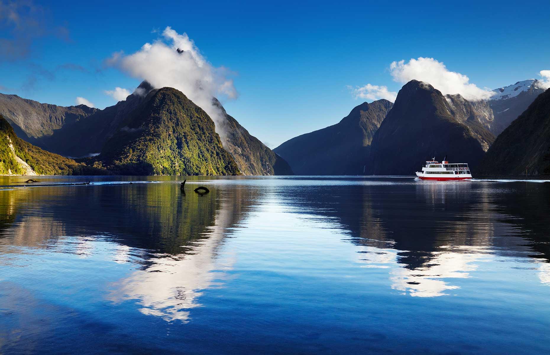 <p>South Island’s Fiordland National Park is one of the most pristine and spectacular places on the planet. The vast fiord known as Milford Sound, or Piopiotahi in the Māori language, has sheer rock walls rising 5,522 feet (1,683m) and a daytime or overnight cruise gives a unique perspective.</p>