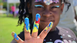 Mikella Graham, 5, from Brooklyn Park talks about her painting at the 2021 Juneteenth Freedom Celebration at Allianz Field in St. Paul on Saturday, June 19, 2021. The event brought together vendors and artist and offered vaccinations groceries. Ramsey County partnered with Minnesota United to host the event. (John Autey / Pioneer Press)