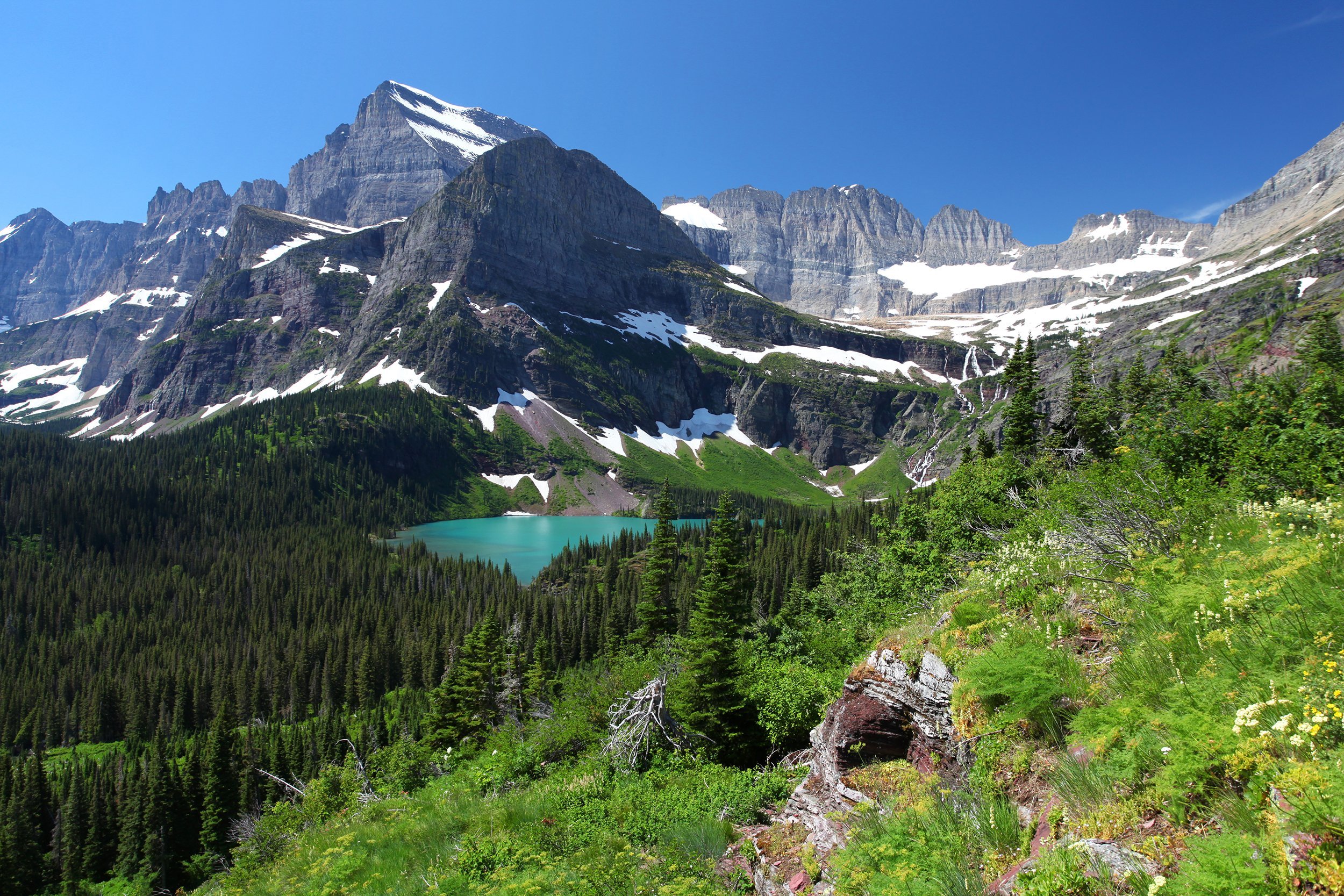 <p><a href="https://www.nps.gov/glac/index.htm">Glacier National Park</a> covers more than 1 million acres and is renowned for its breathtaking beauty and rugged terrain. Iconic Red Bus tours and a free shuttle system travel along Going-to-the-Sun Road, a 50-mile route with unparalleled scenic vistas. Guests can stay at one of 13 drive-in campgrounds, backcountry chalets, cabins, and historic hotels. Spaces fill quickly, so it pays to book early. <a href="https://www.glaciernationalparklodges.com/red-bus-tours">Red Bus tour</a> booking is underway.</p><p><b>Related:</b> <a href="https://blog.cheapism.com/bucket-list-roads/">Bucket List Roads to Drive Around the World</a></p>